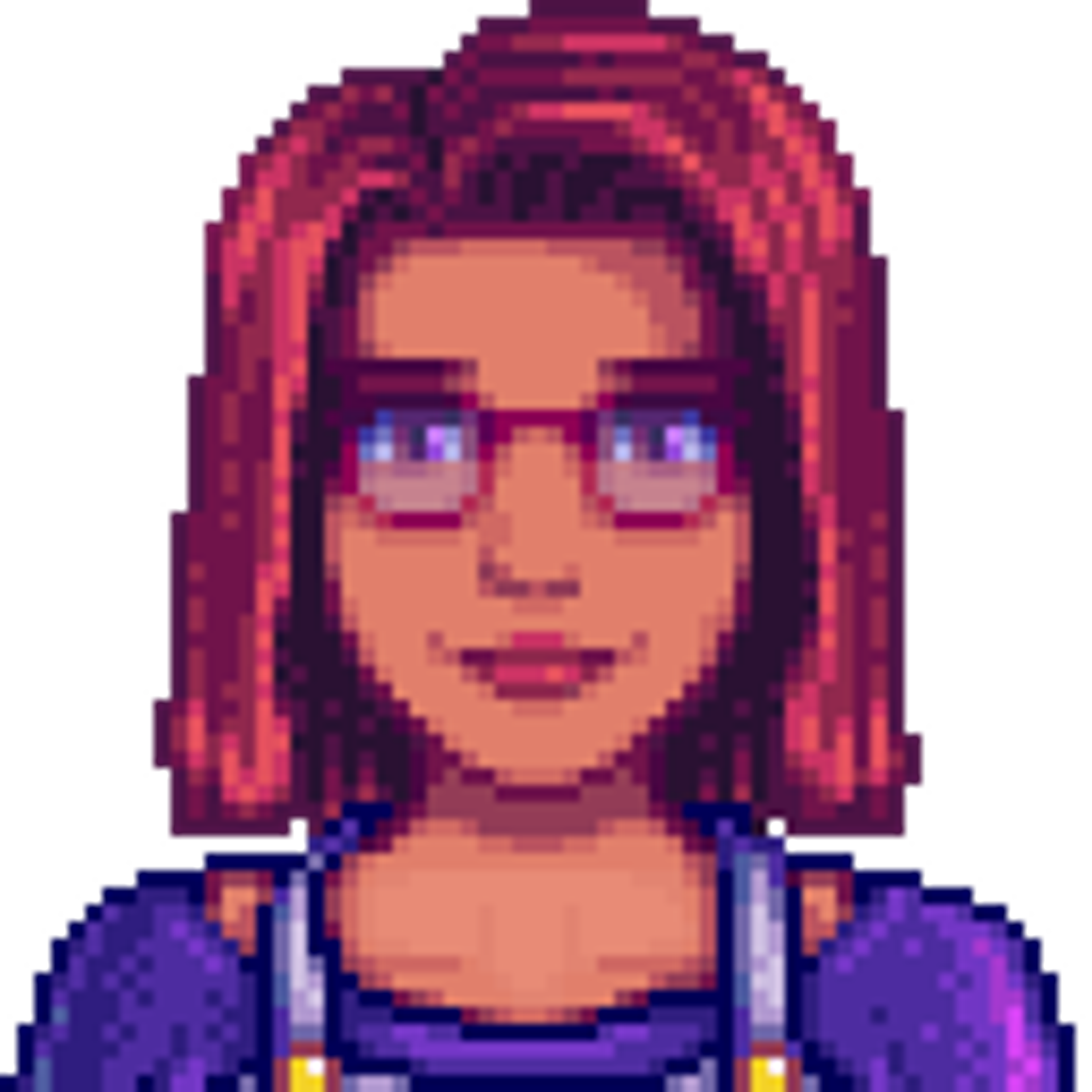 A young woman with red hair and glasses smiling at the camera