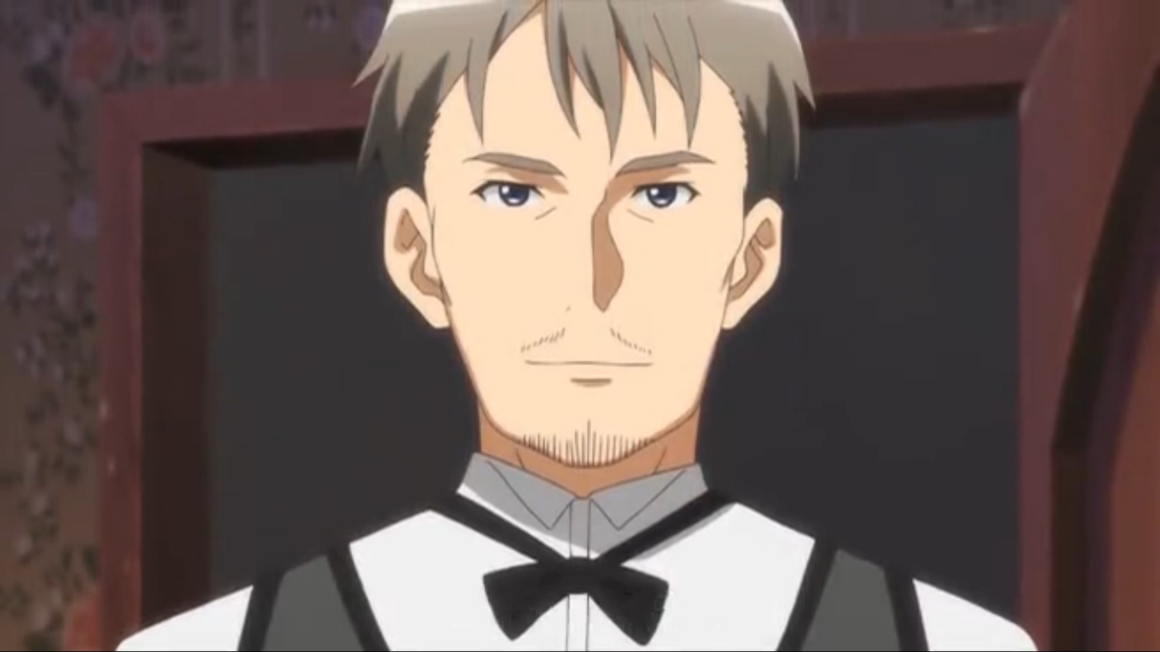 A middle-aged man in a bartender's uniform with short, dull brown-grey hair and a light layer of facial hair