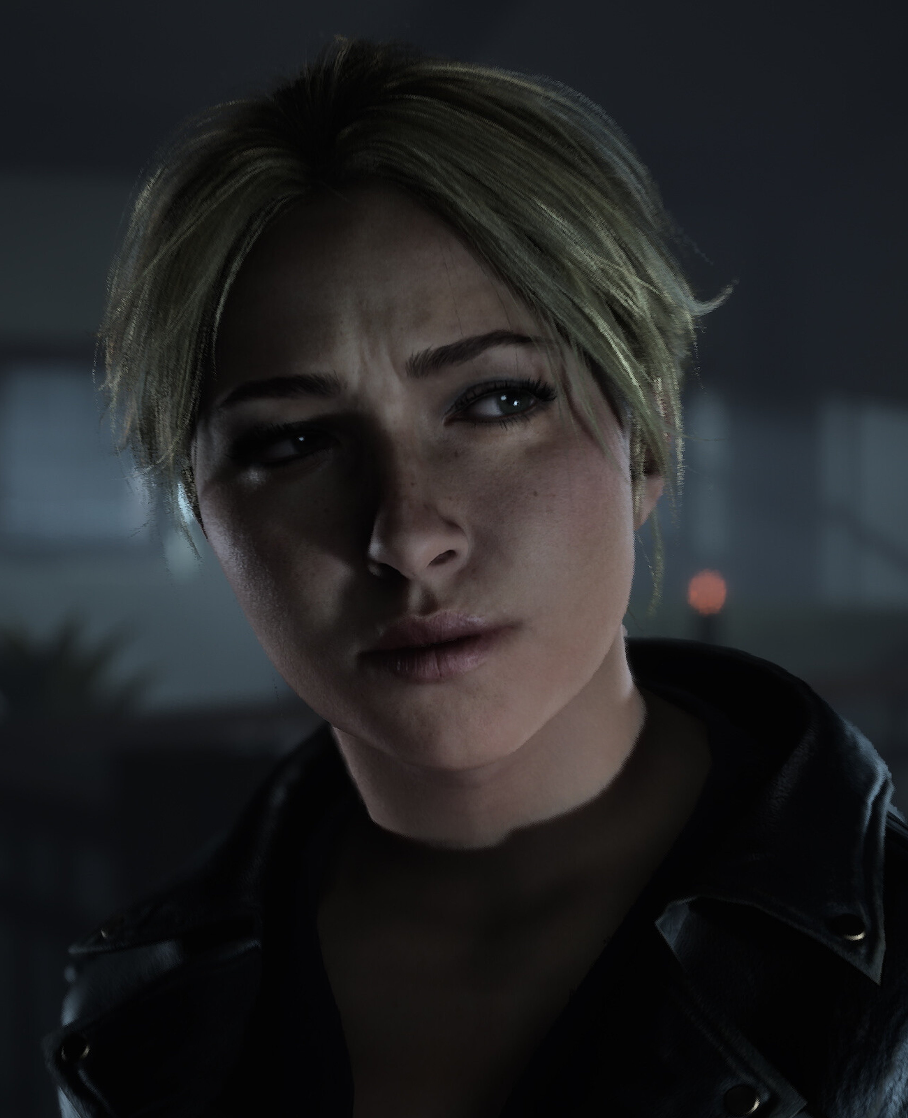 A young woman with short blonde hair wearing a black leather jacket in a dark, moody environment.