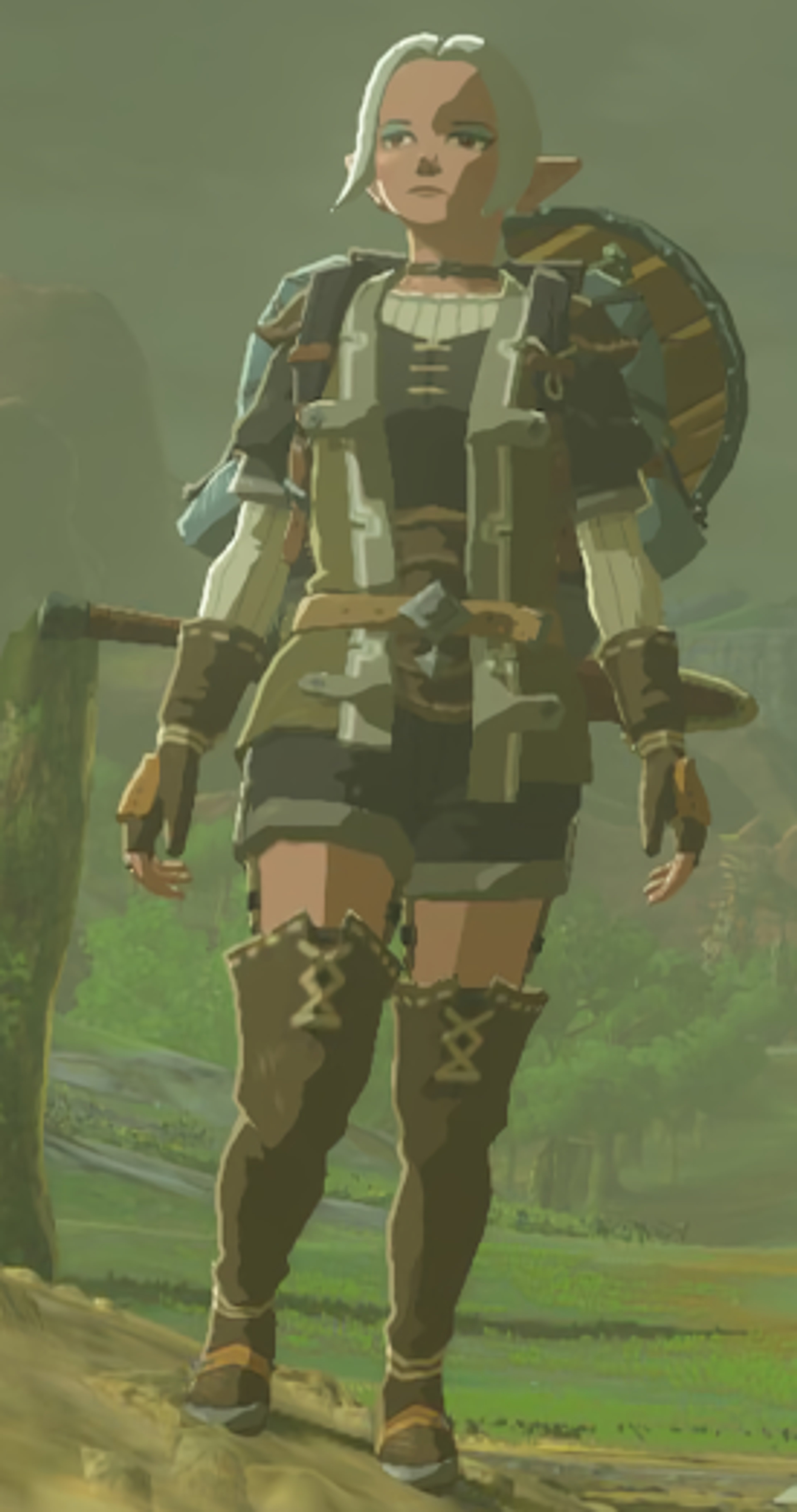 A female character with blonde hair wearing green and brown armor-like clothing, holding a weapon and standing in an outdoor environment.