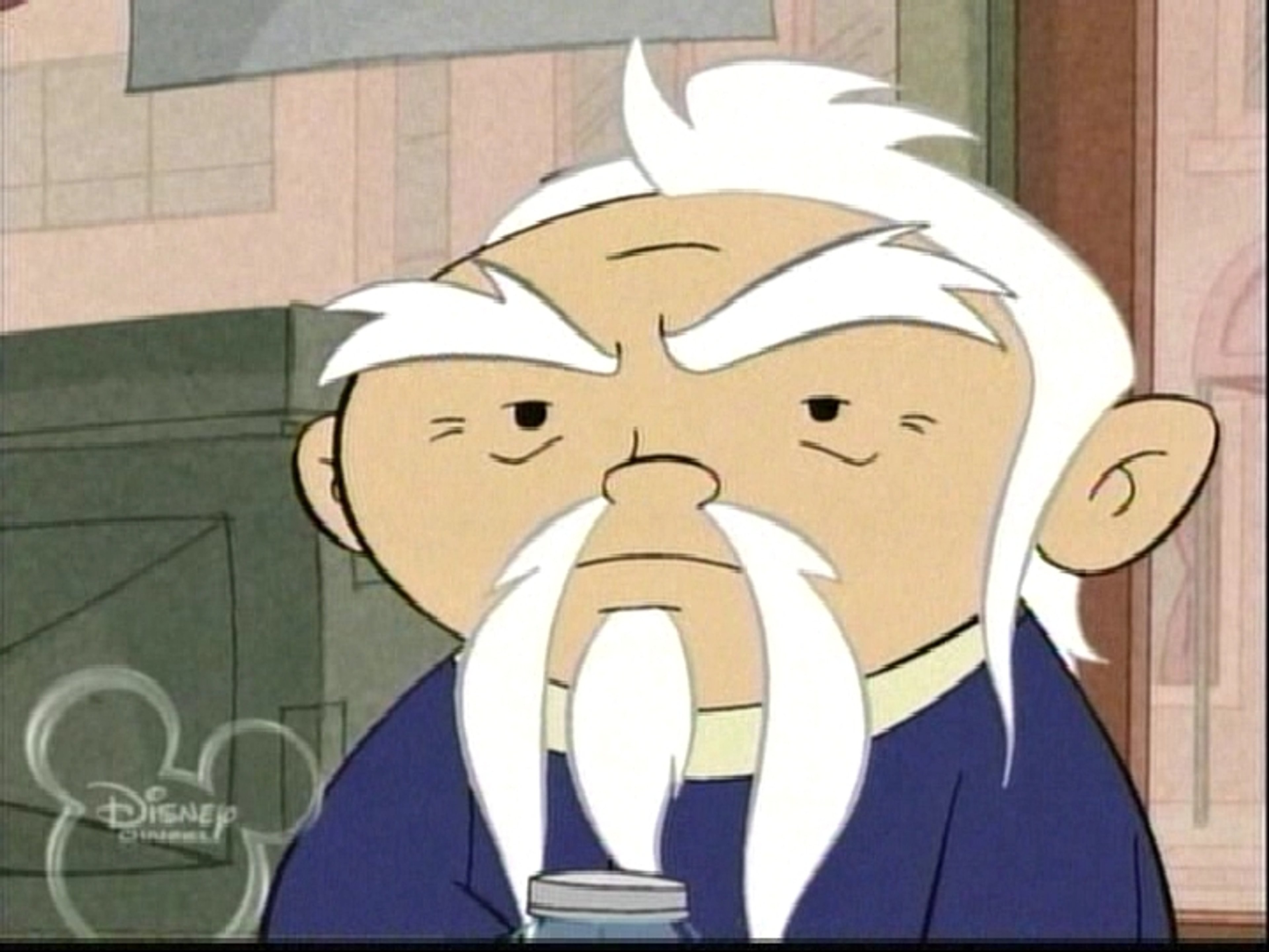 An elderly Asian man with thinning white hair, thick eyebrows, and a Fu Manchu mustache with a soul patch beard, wearing a long-sleeved blue robe with yellow trim.