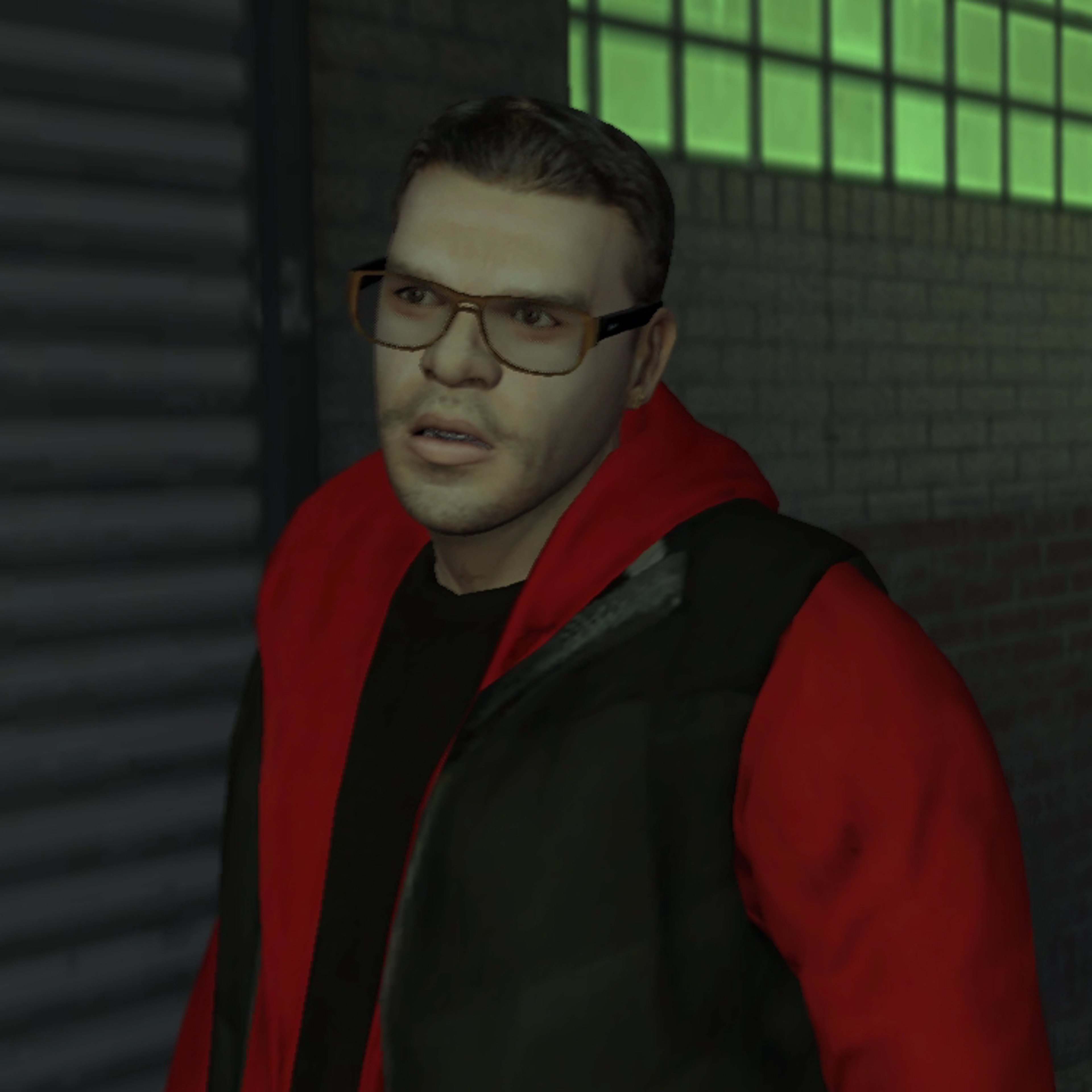 A man with short dark hair and glasses wearing a red jacket in an urban setting