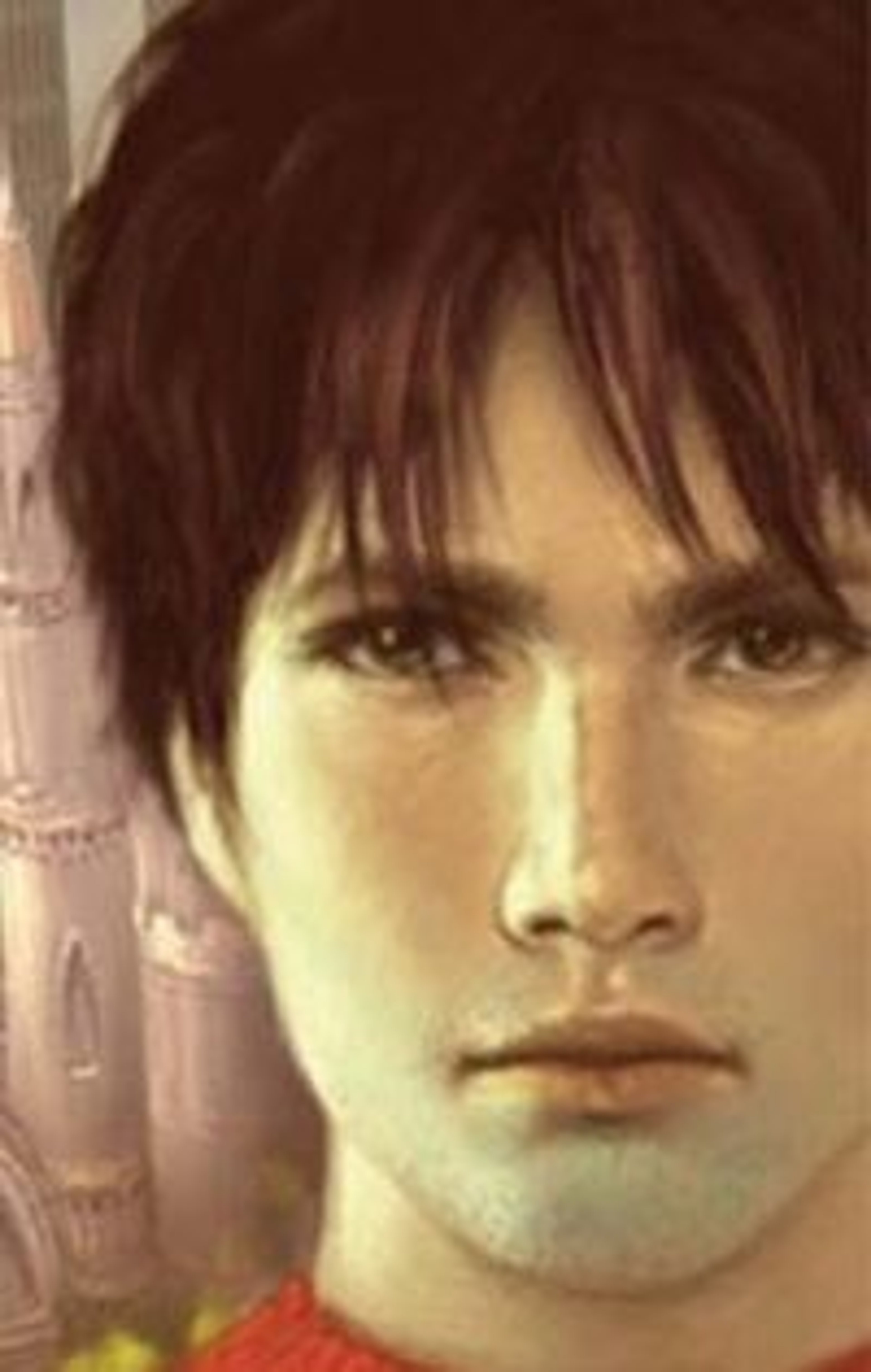 A young man with dark hair and a serious expression