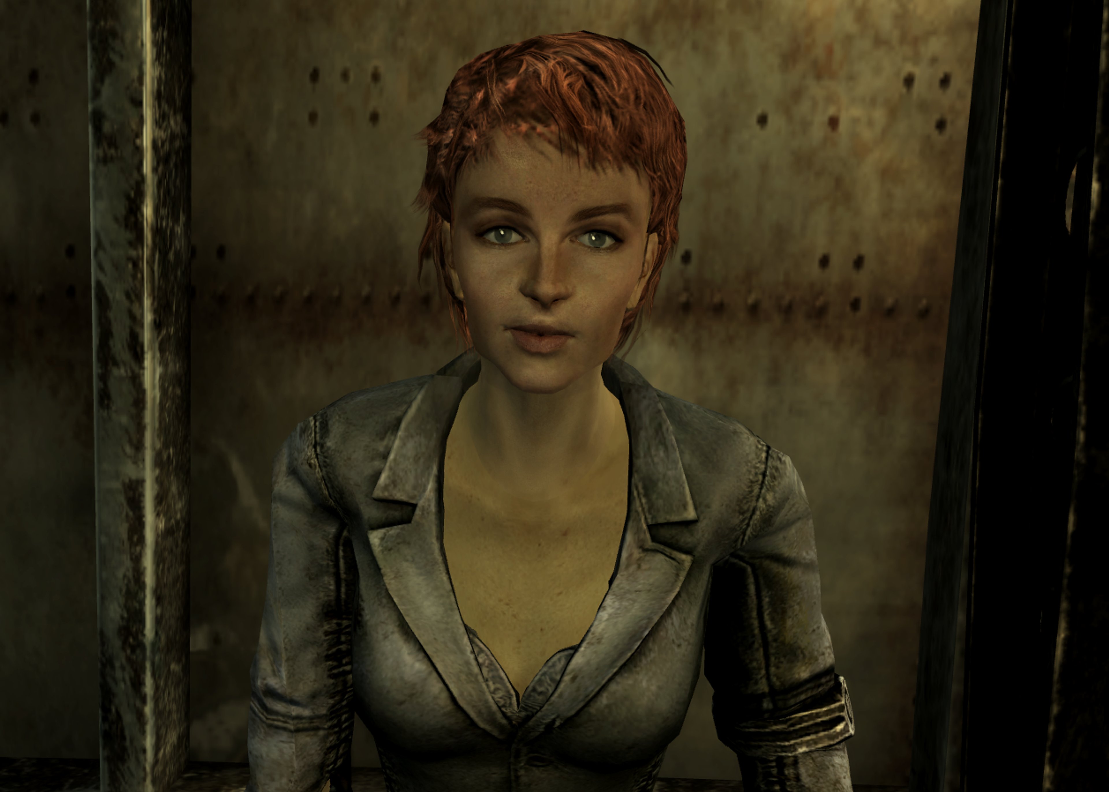 A woman with short, reddish-brown hair wearing a black leather jacket in a post-apocalyptic setting
