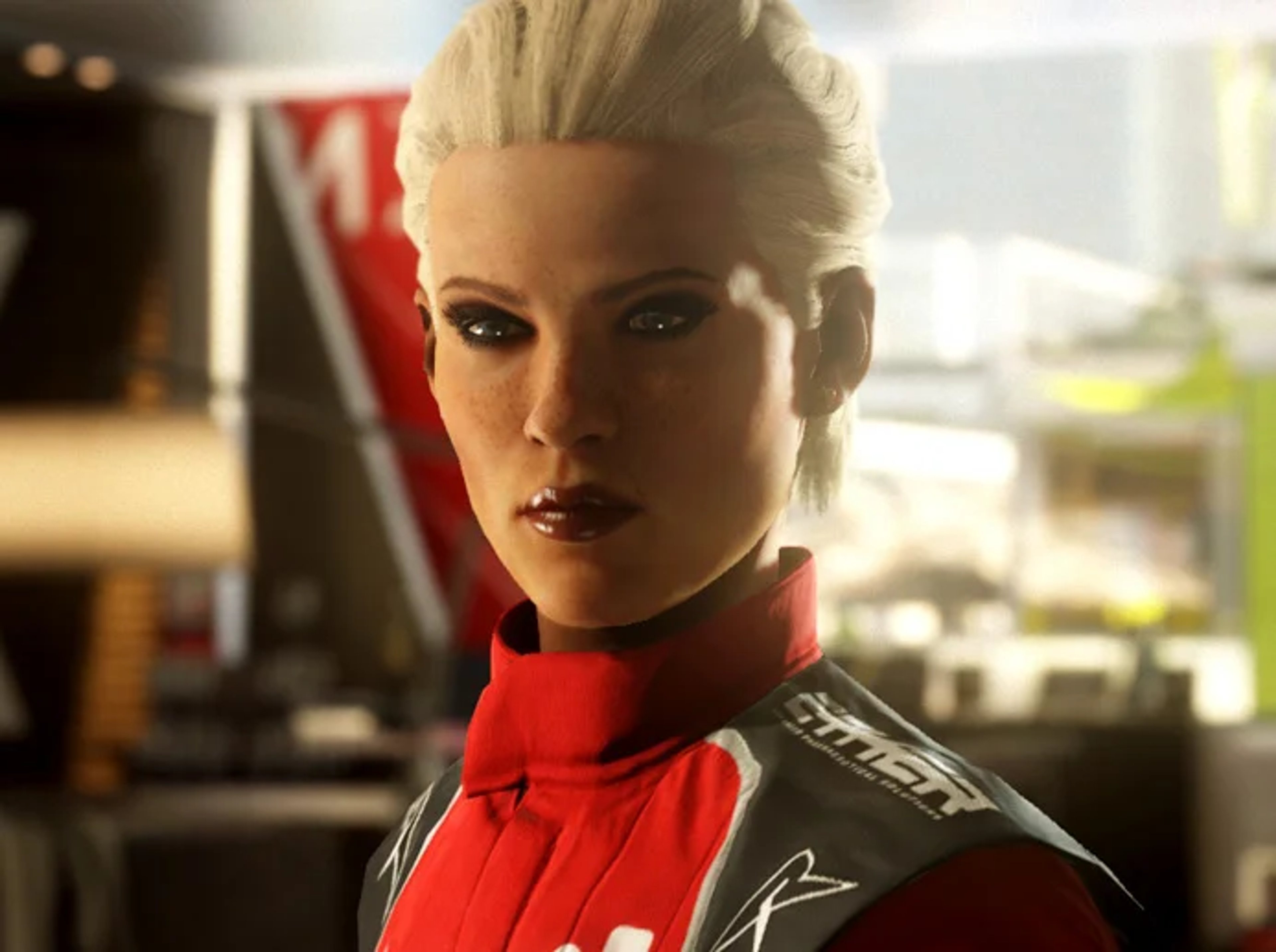 A woman in a red racing suit with a serious expression