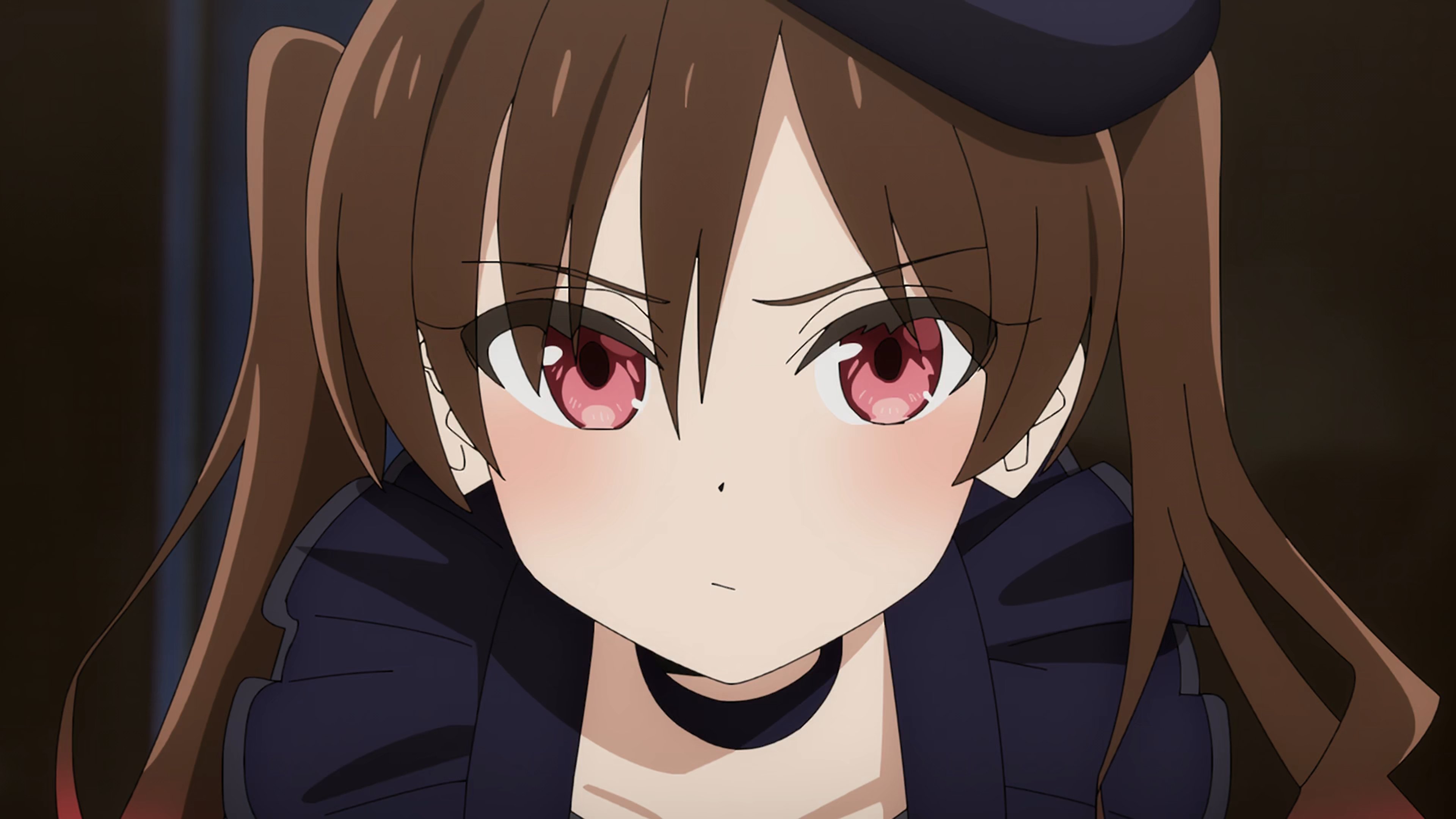 An anime-style character with long brown hair in pigtails, wearing a dark blue jacket or shirt and having a serious expression.