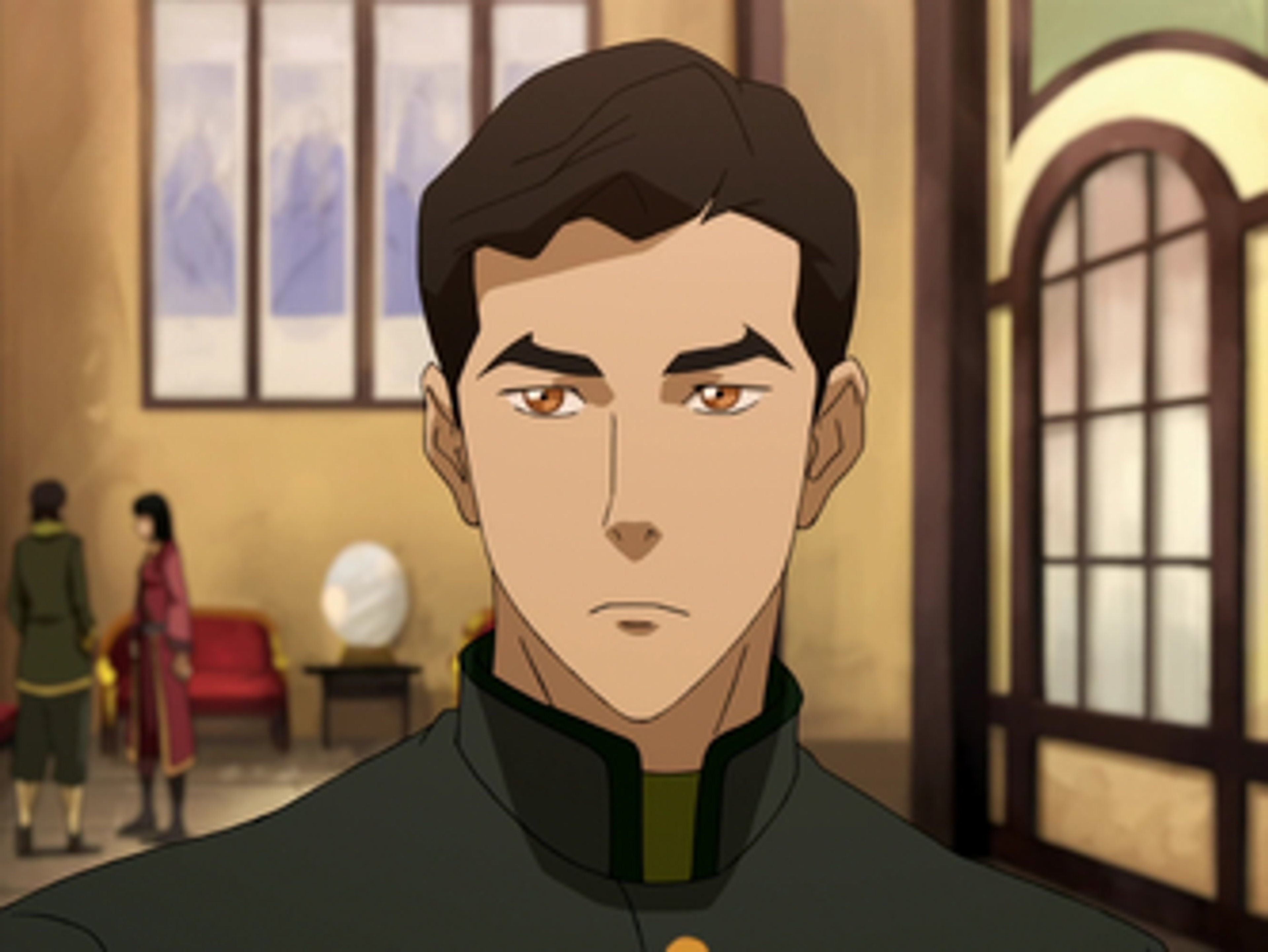 A young man with dark hair and a serious expression