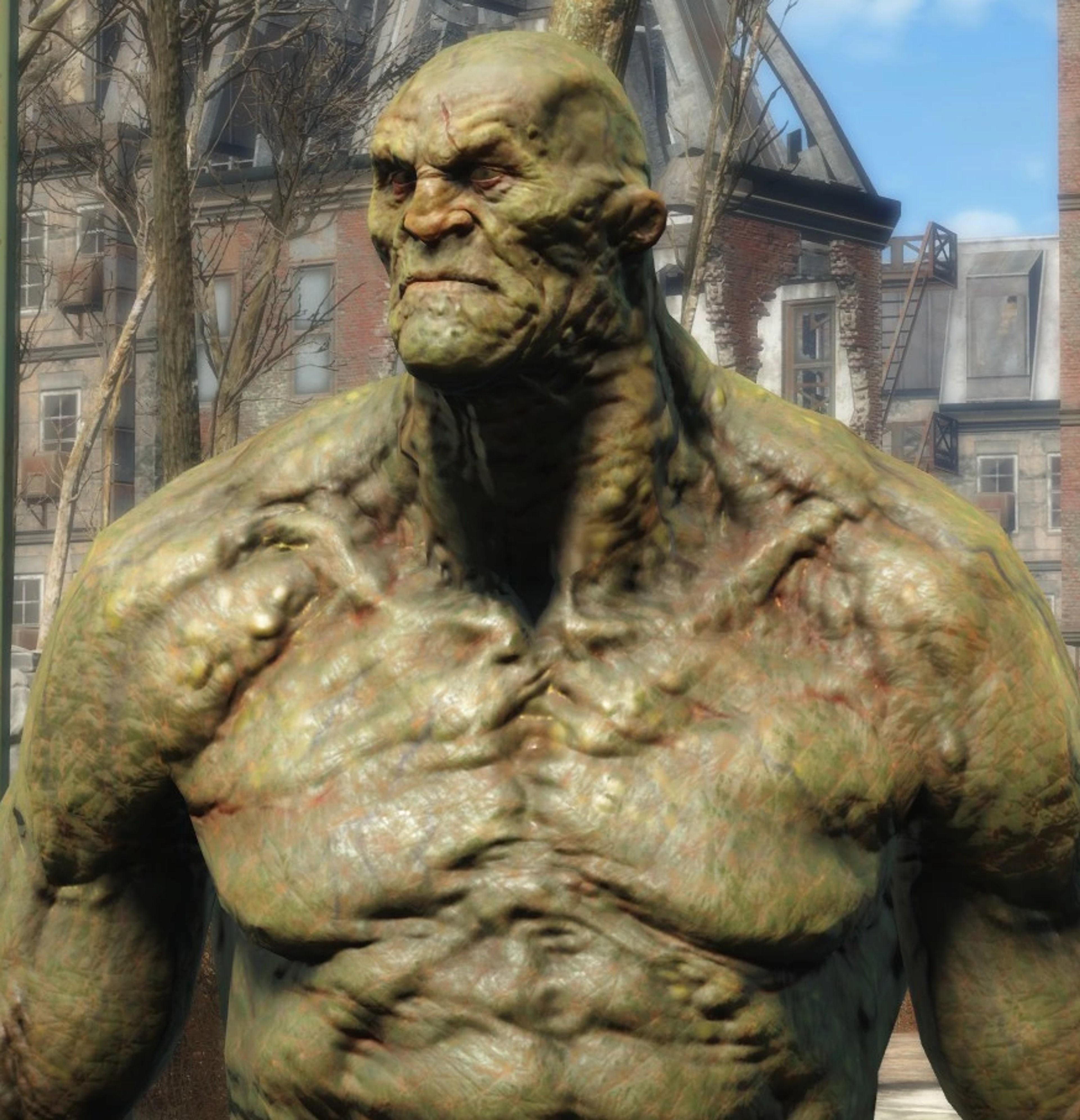 A large, green-skinned super mutant with an imposing, muscular physique.