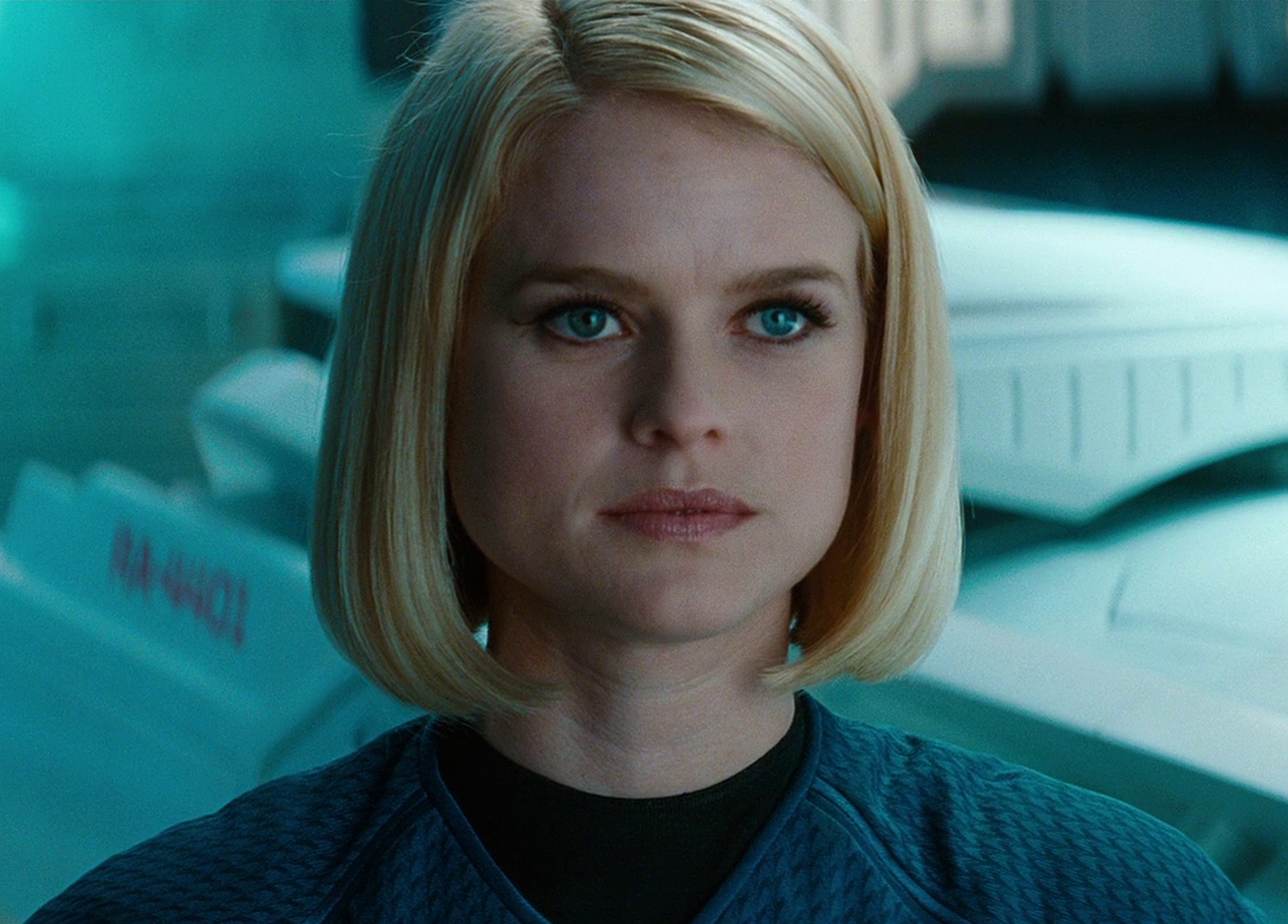 A woman in a Starfleet uniform with blonde hair and blue eyes