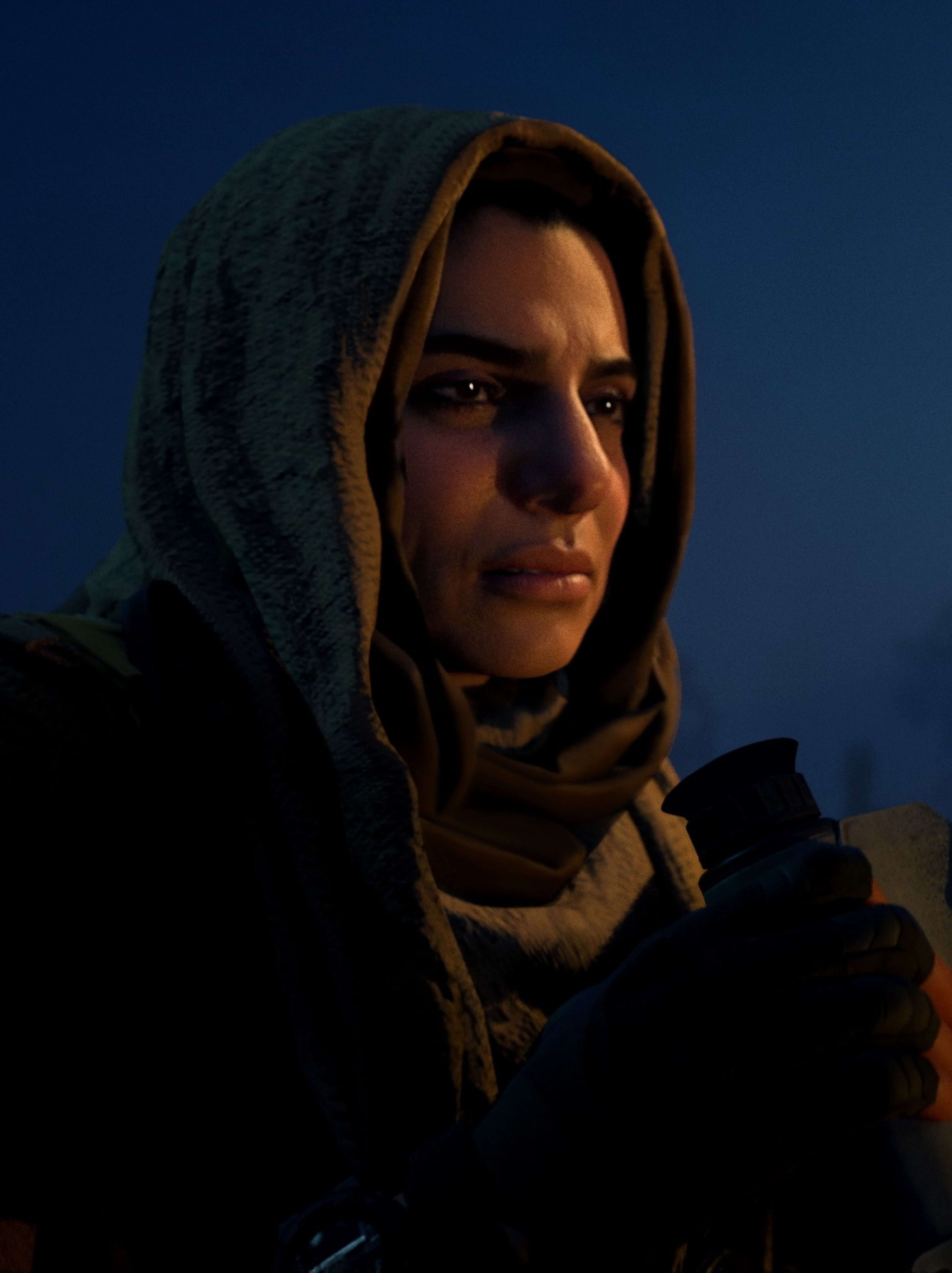 A woman with a hooded scarf looking determined in a dark outdoor setting