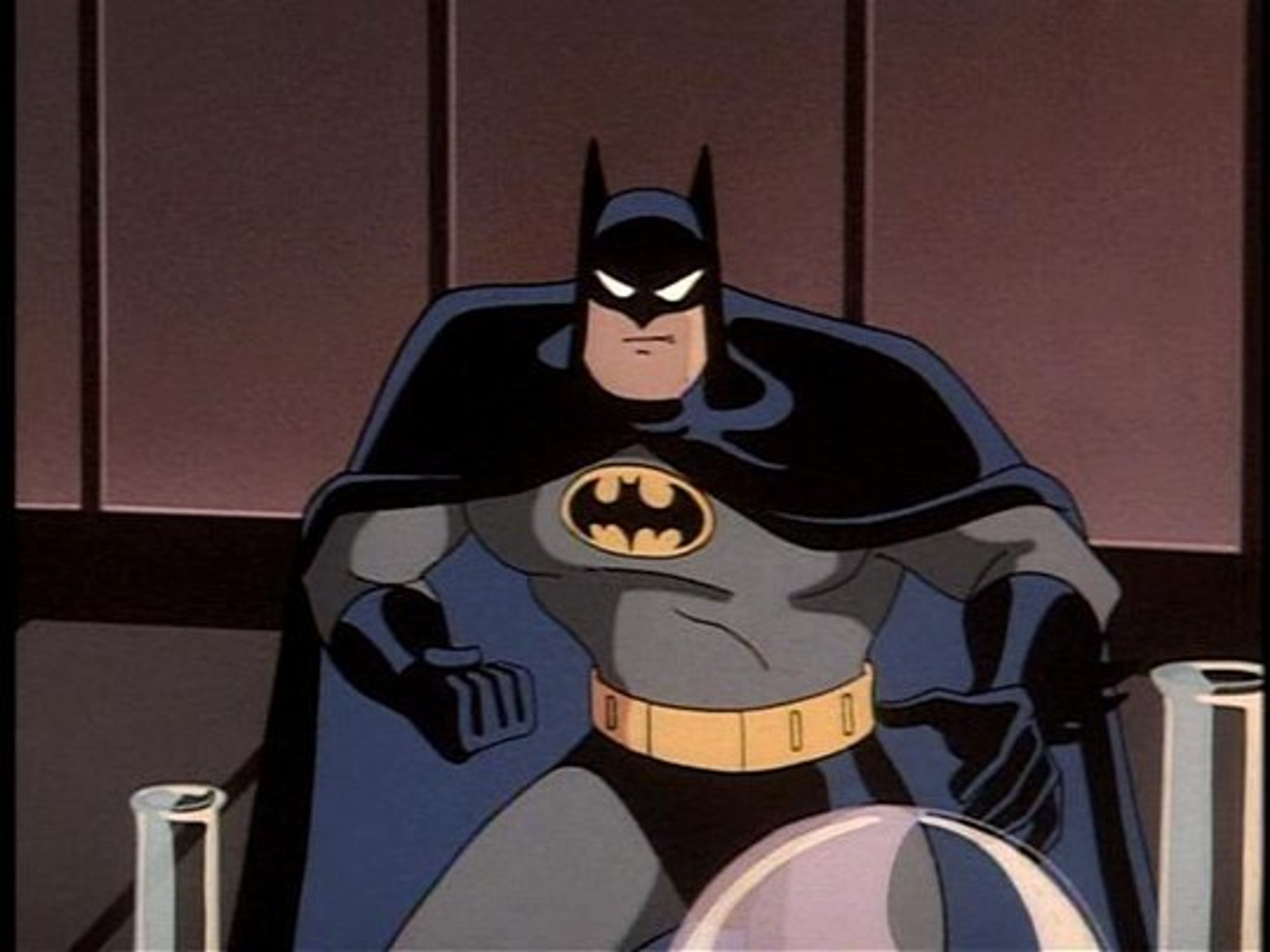 Batman, the Dark Knight, standing in a dark, moody environment.