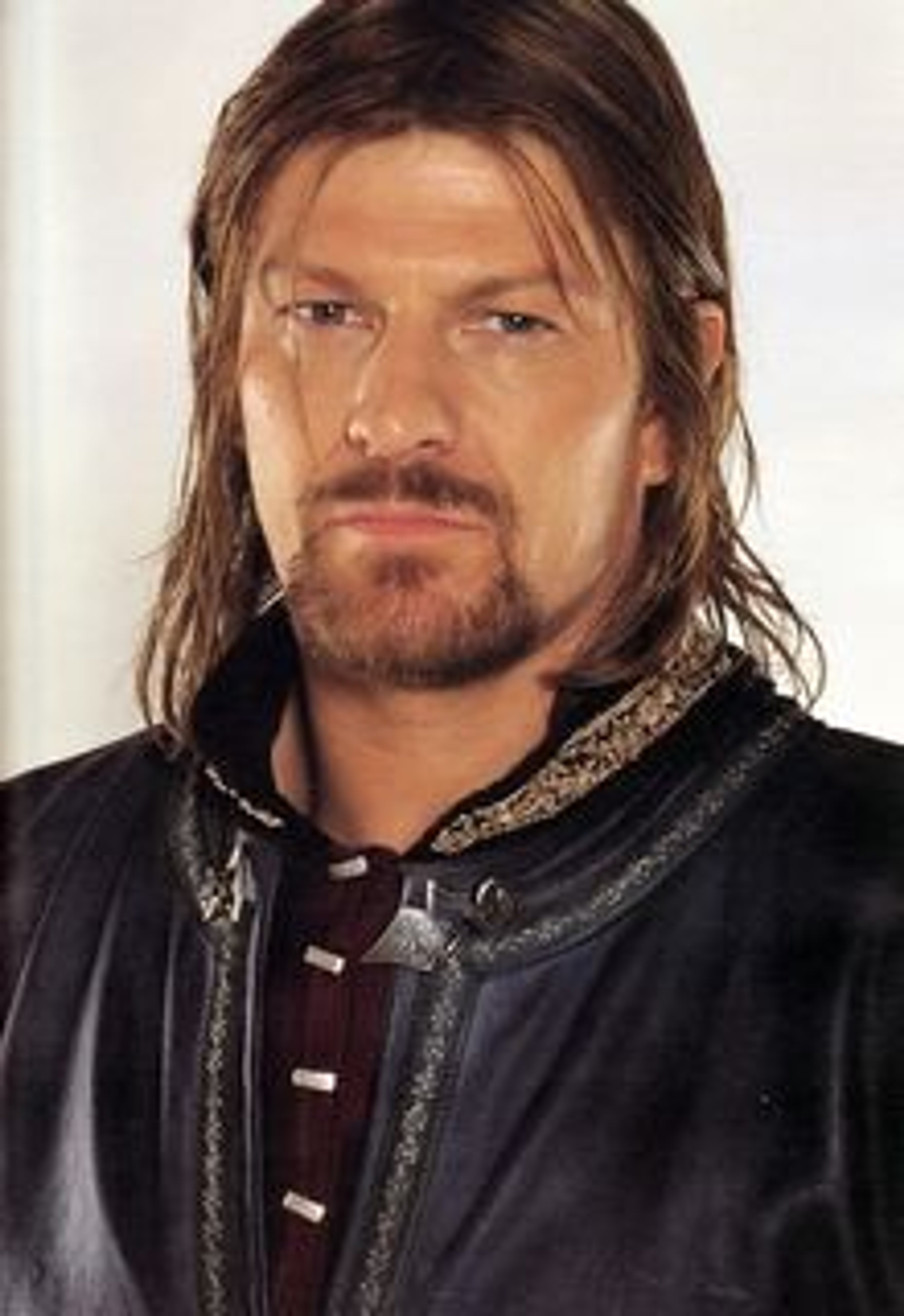 A middle-aged man with long, dark hair and a beard wearing a black leather jacket