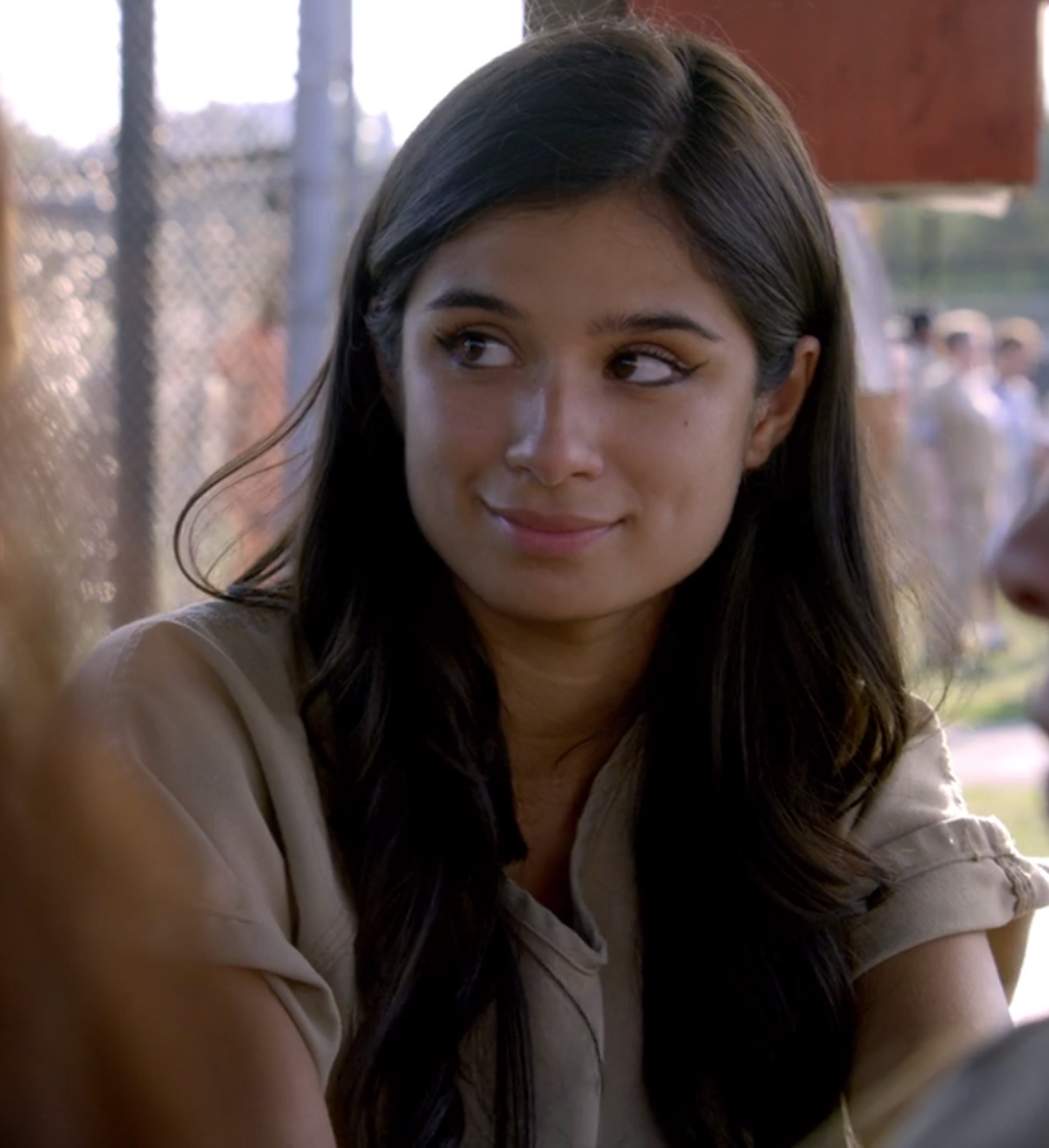 A young woman with long dark hair and a friendly expression