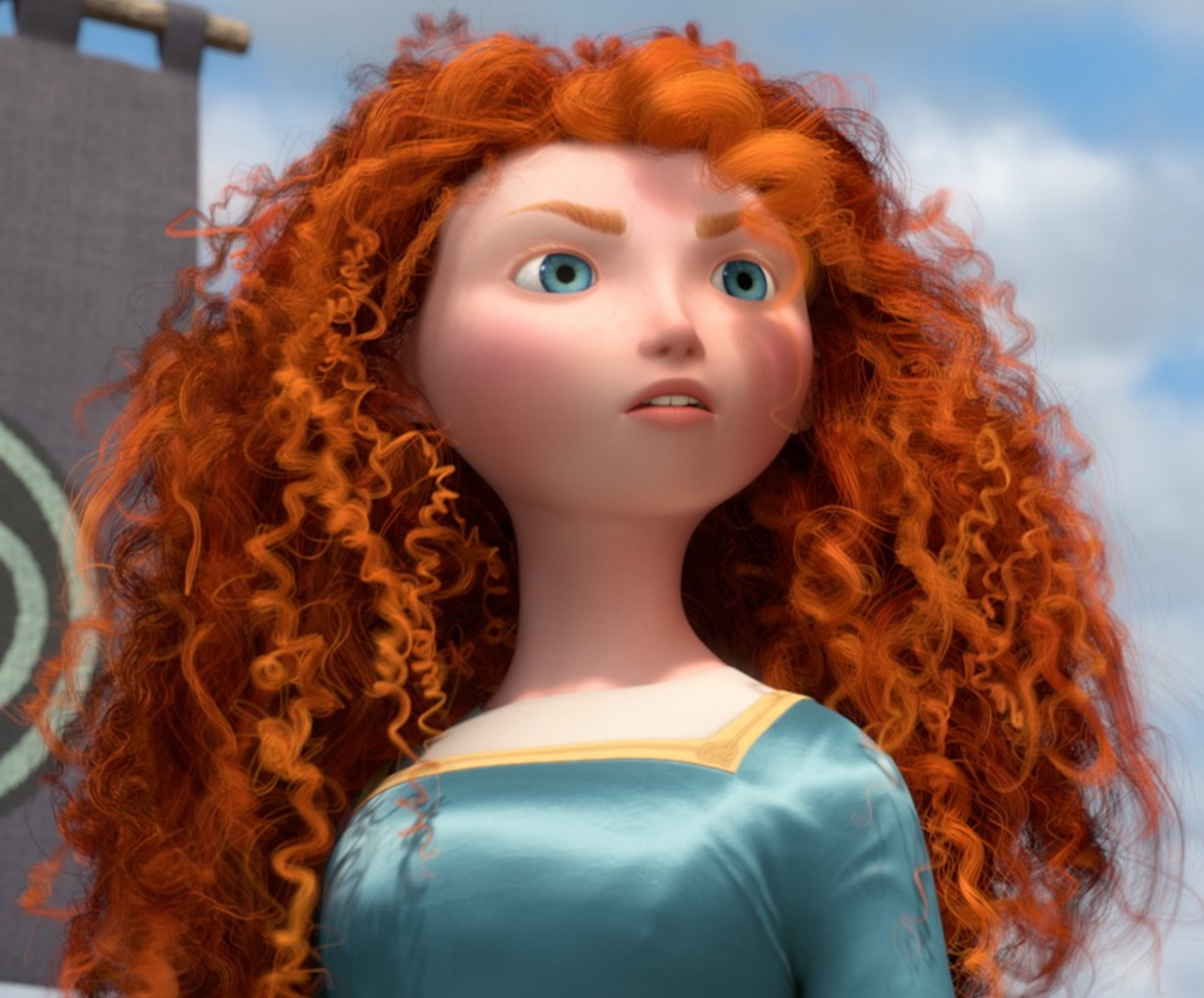 A young woman with long, curly red hair wearing a green medieval-style dress