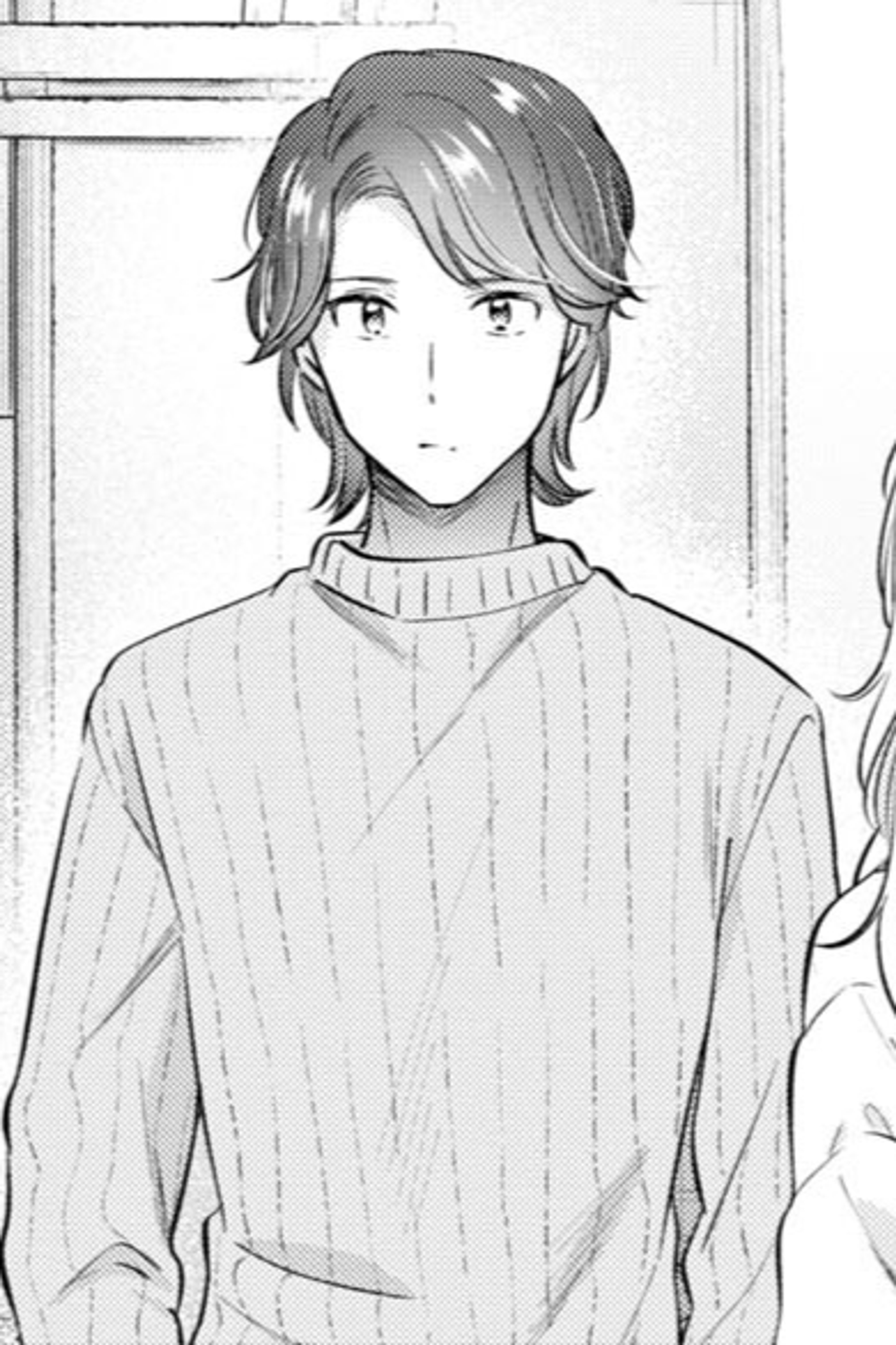 A young, handsome man with short, dark hair in a casual, domestic setting