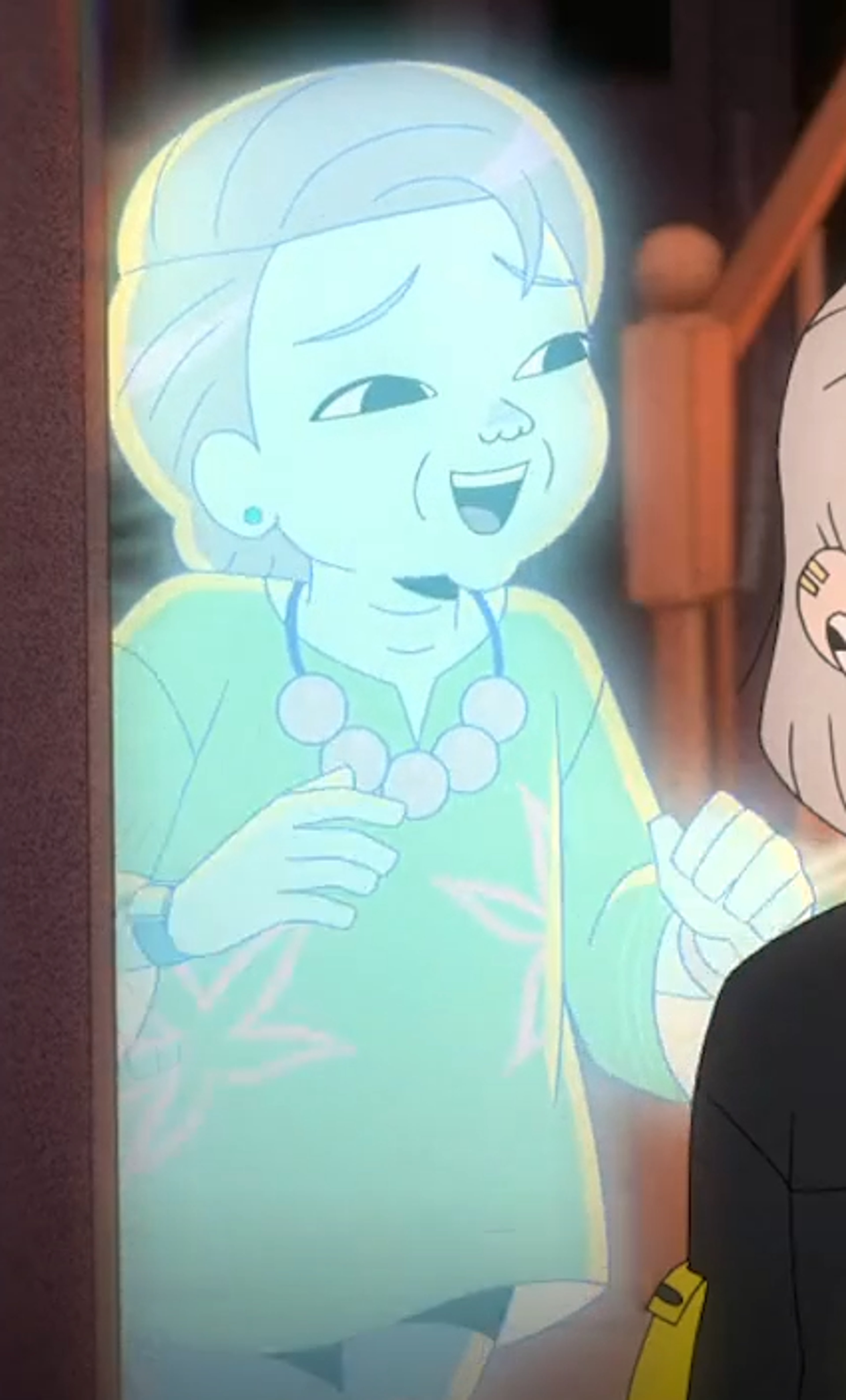 An elderly Asian woman with short gray hair and black eyes, wearing seafoam green jewelry and a yellow floral shirt.