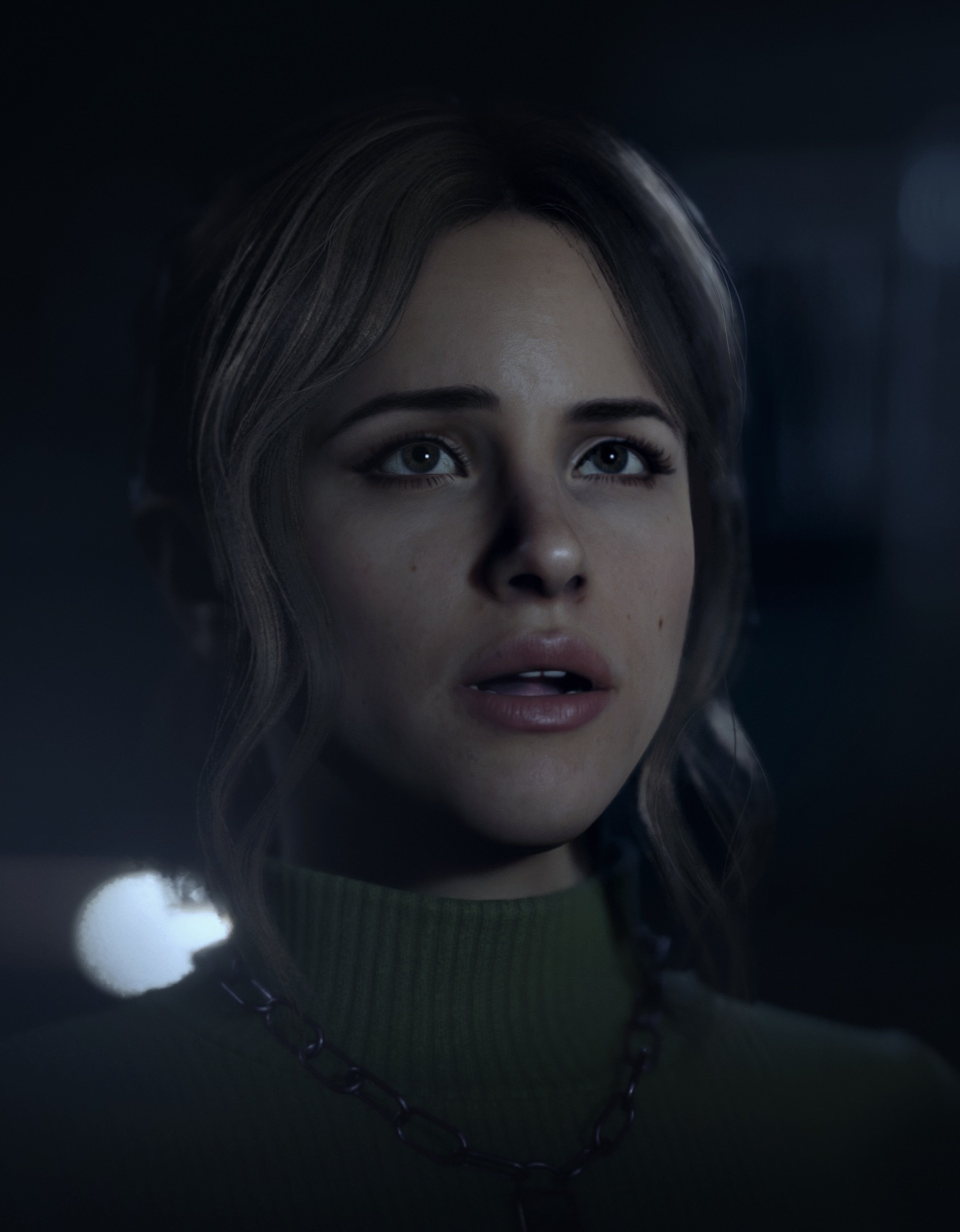 A close-up portrait of a young woman with a serious expression on her face.