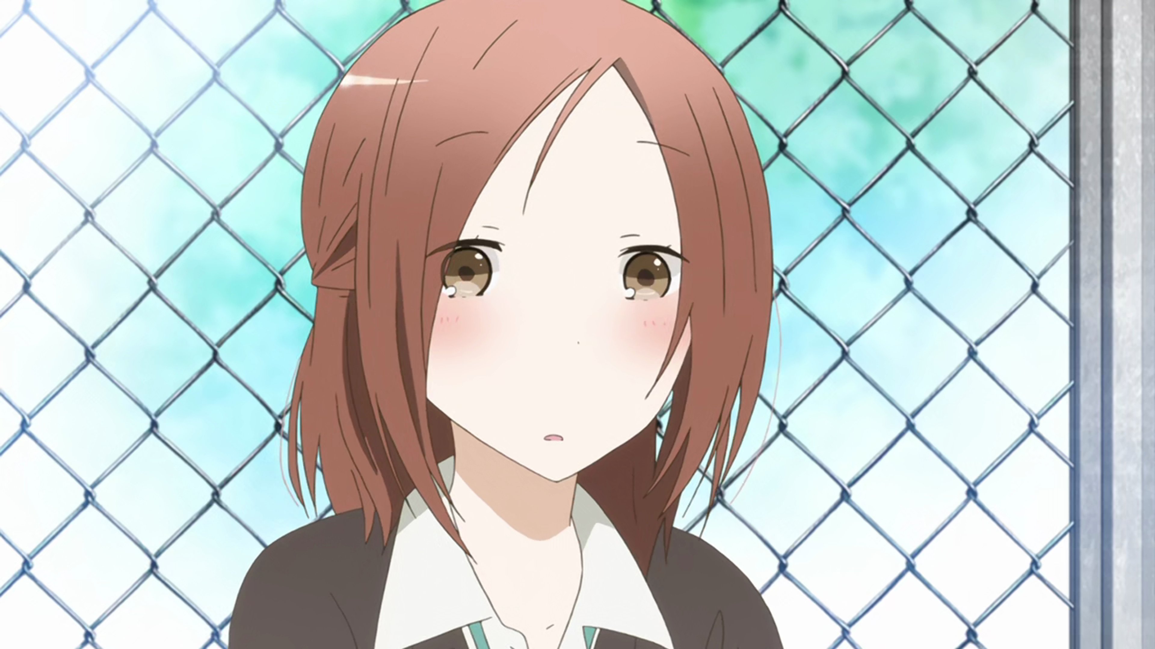 A young woman with light brown hair and amber eyes wearing a school uniform