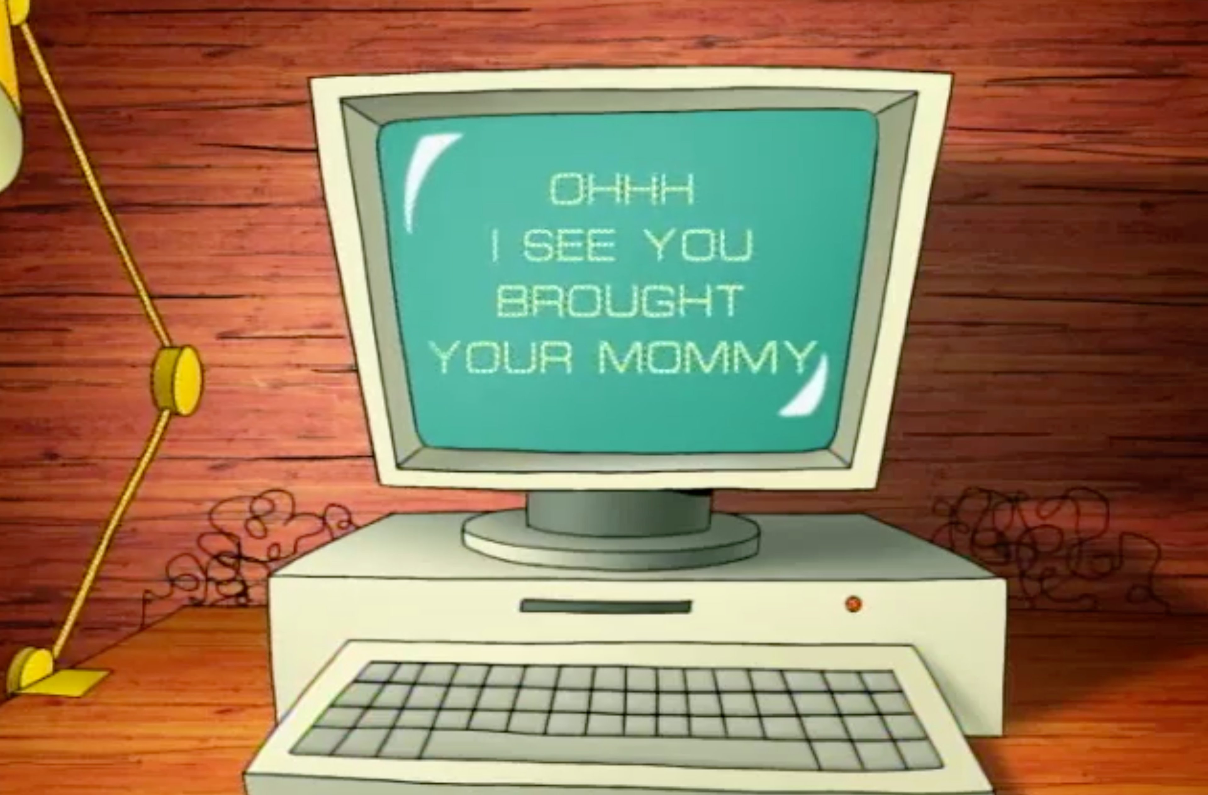 An old desktop computer with a CRT monitor displaying sarcastic text