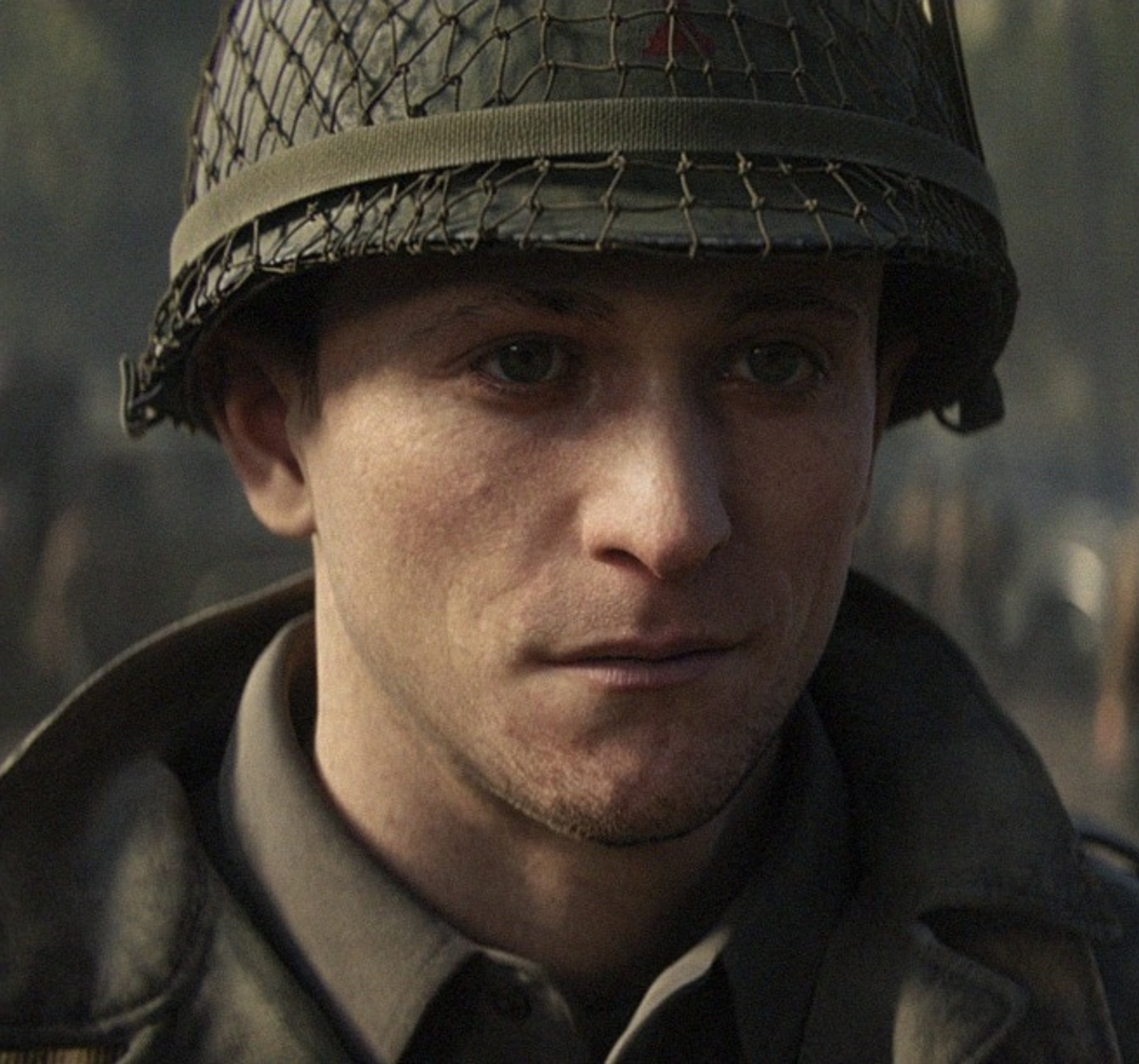 A young male soldier in a World War II military uniform and helmet