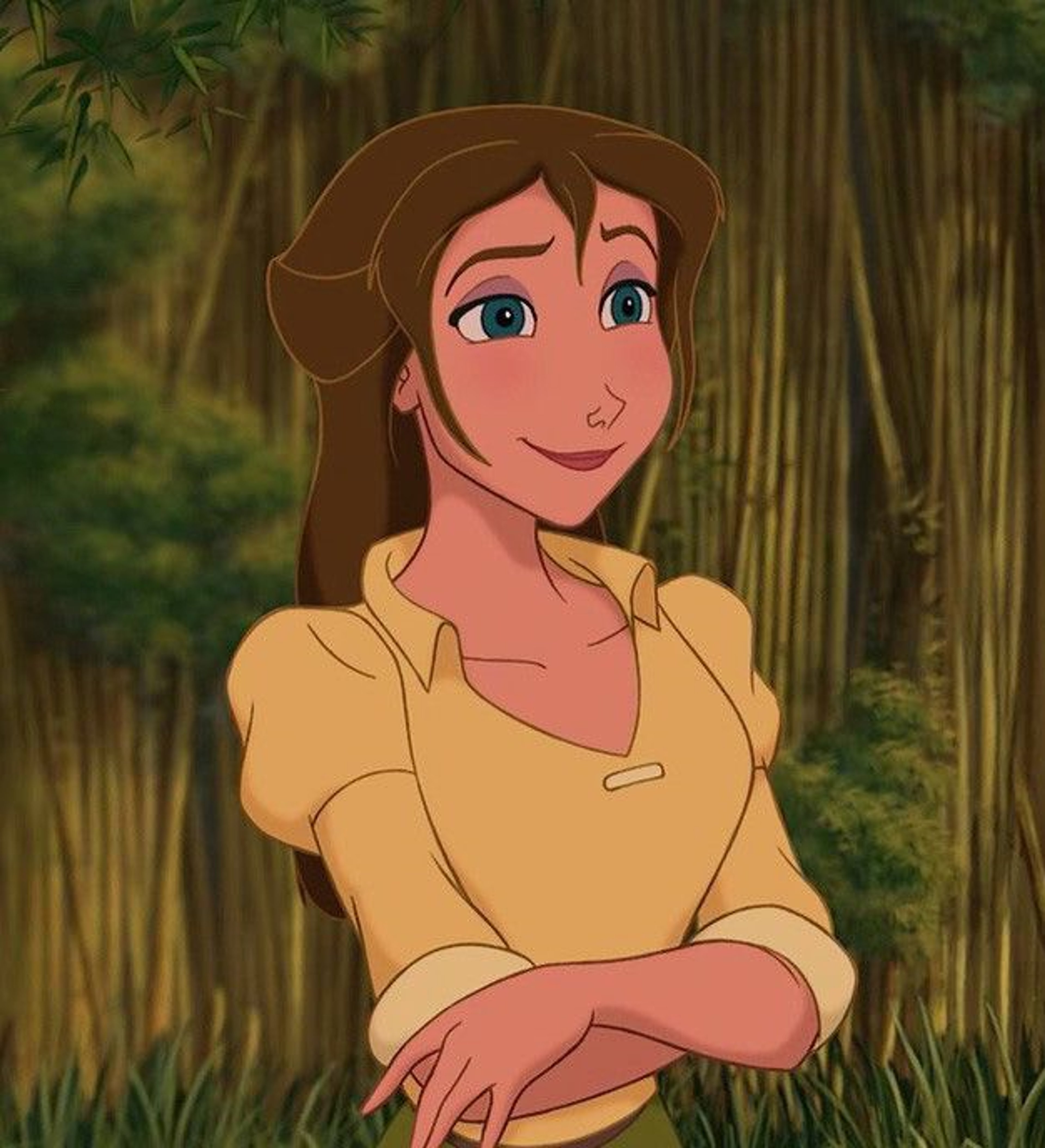A young, animated woman with brown hair and blue eyes wearing a yellow shirt