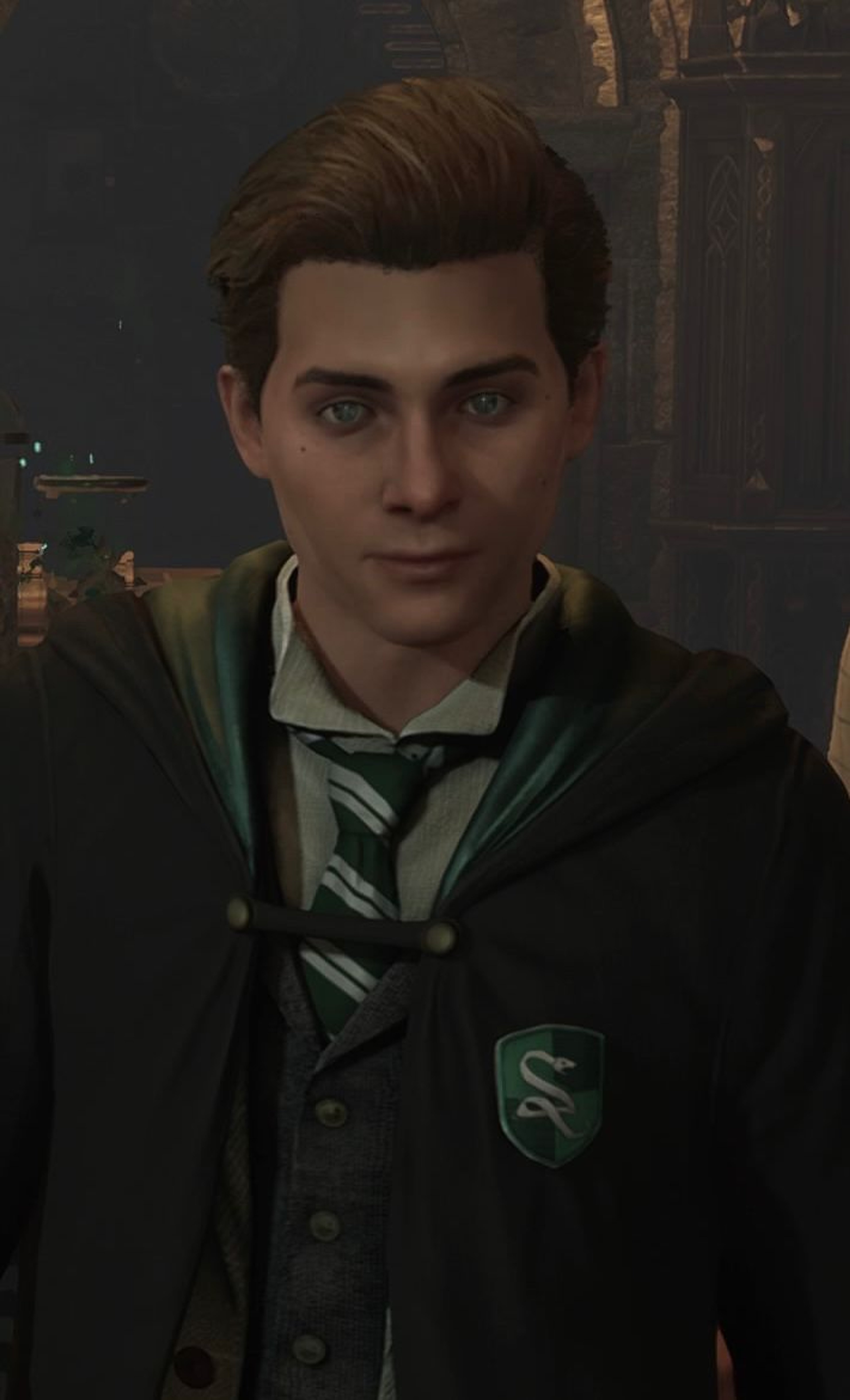A young wizard with dark hair and green eyes, wearing a dark suit and tie, with a serious expression on his face.