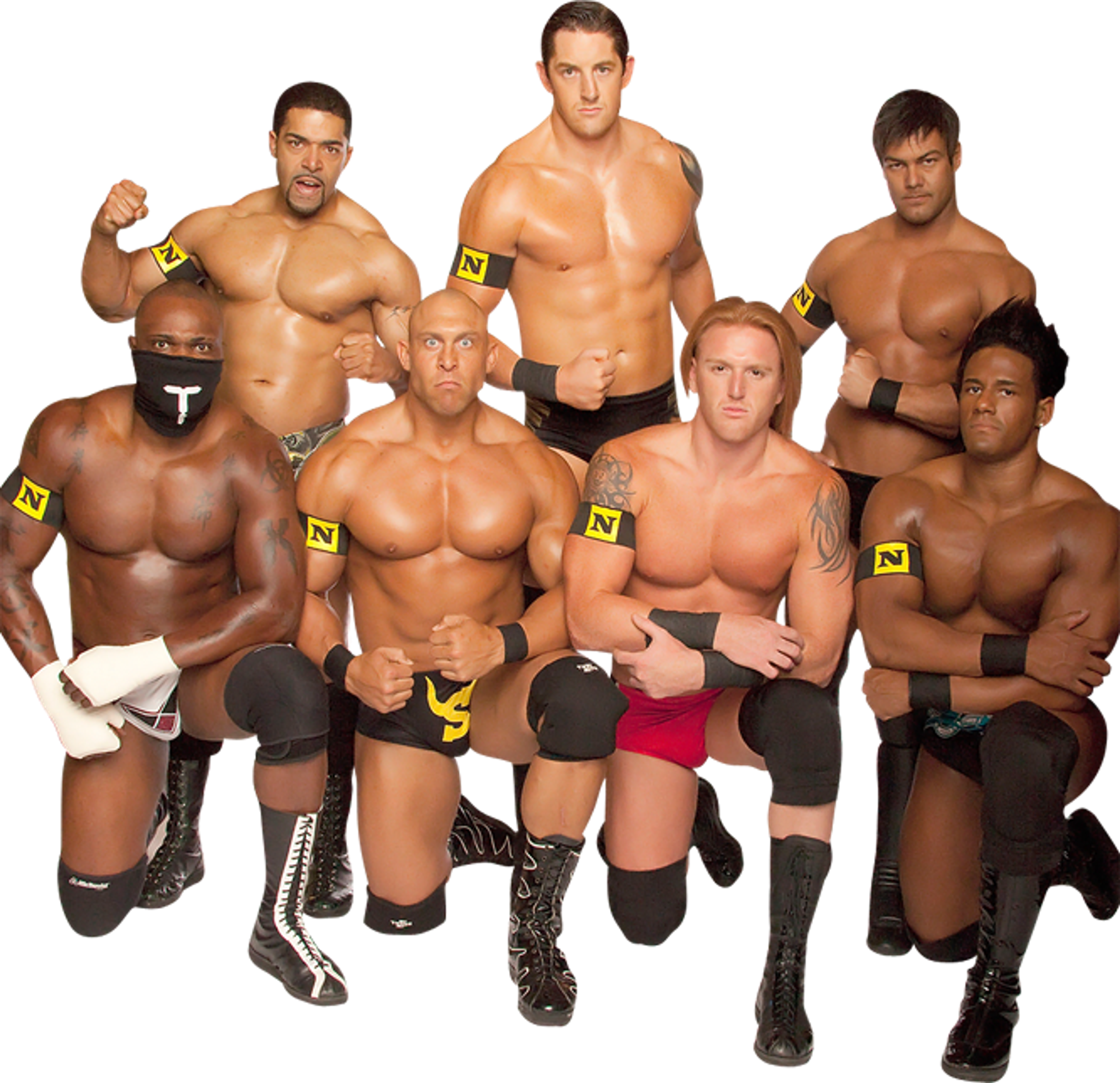 A group of muscular male wrestlers in black and yellow attire posing together