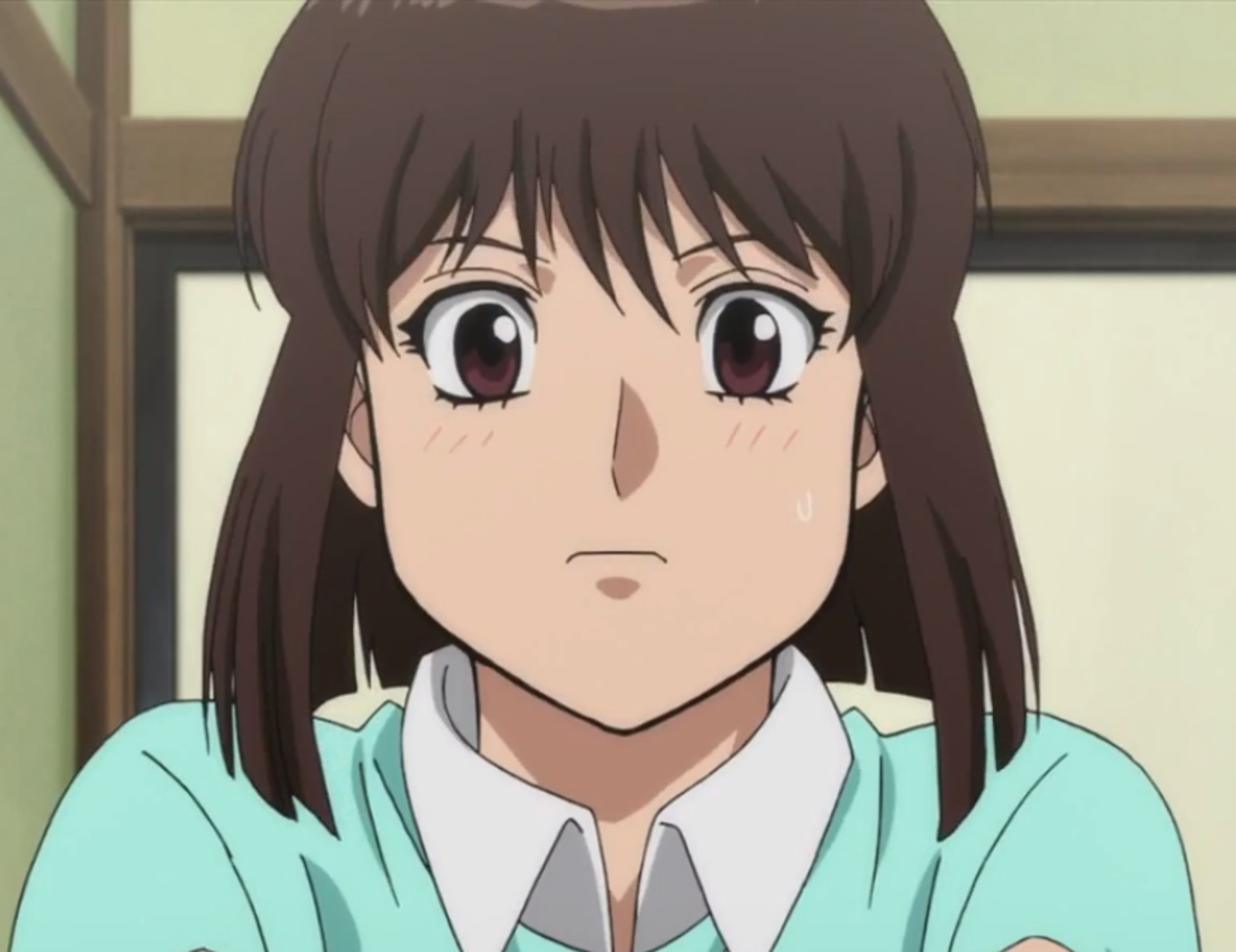 A young woman with long dark hair and a kind expression