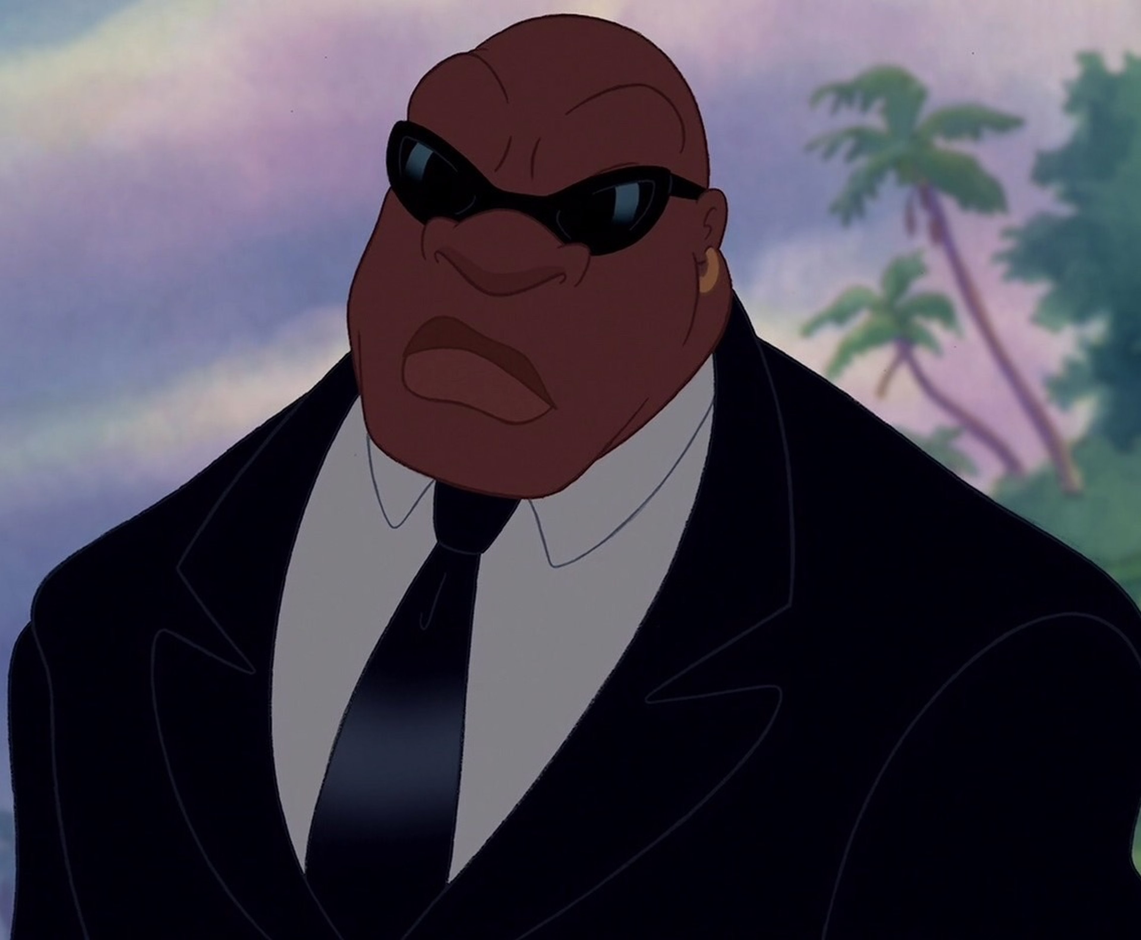 An intimidating African-American man in a suit and sunglasses