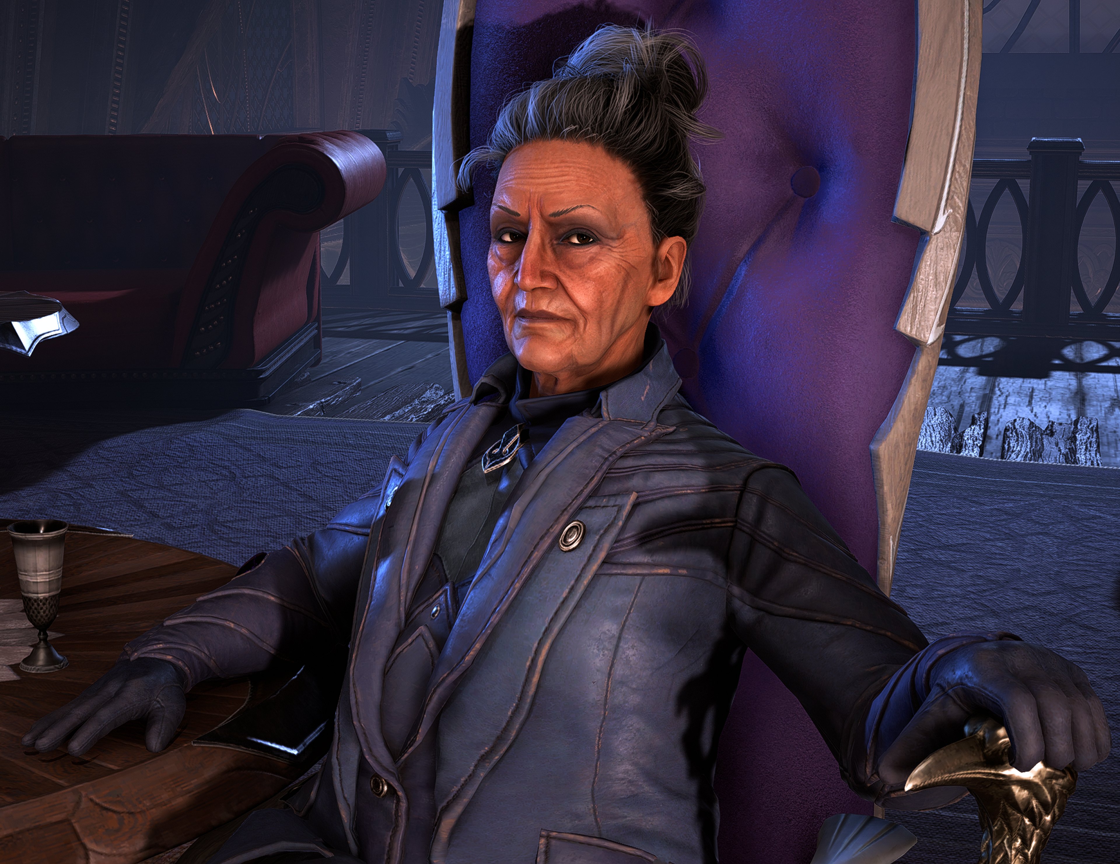 A serious-looking older woman with silver-white hair wearing a dark jacket