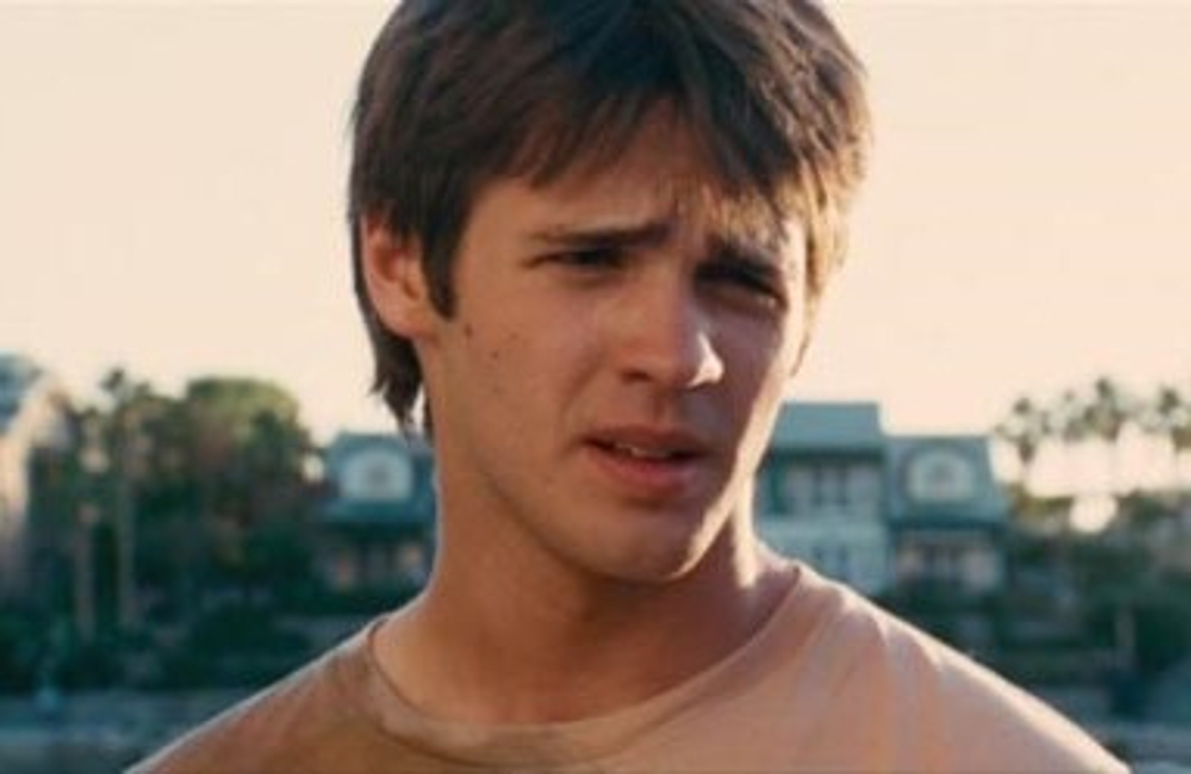 A young man with short dark hair and a casual outfit