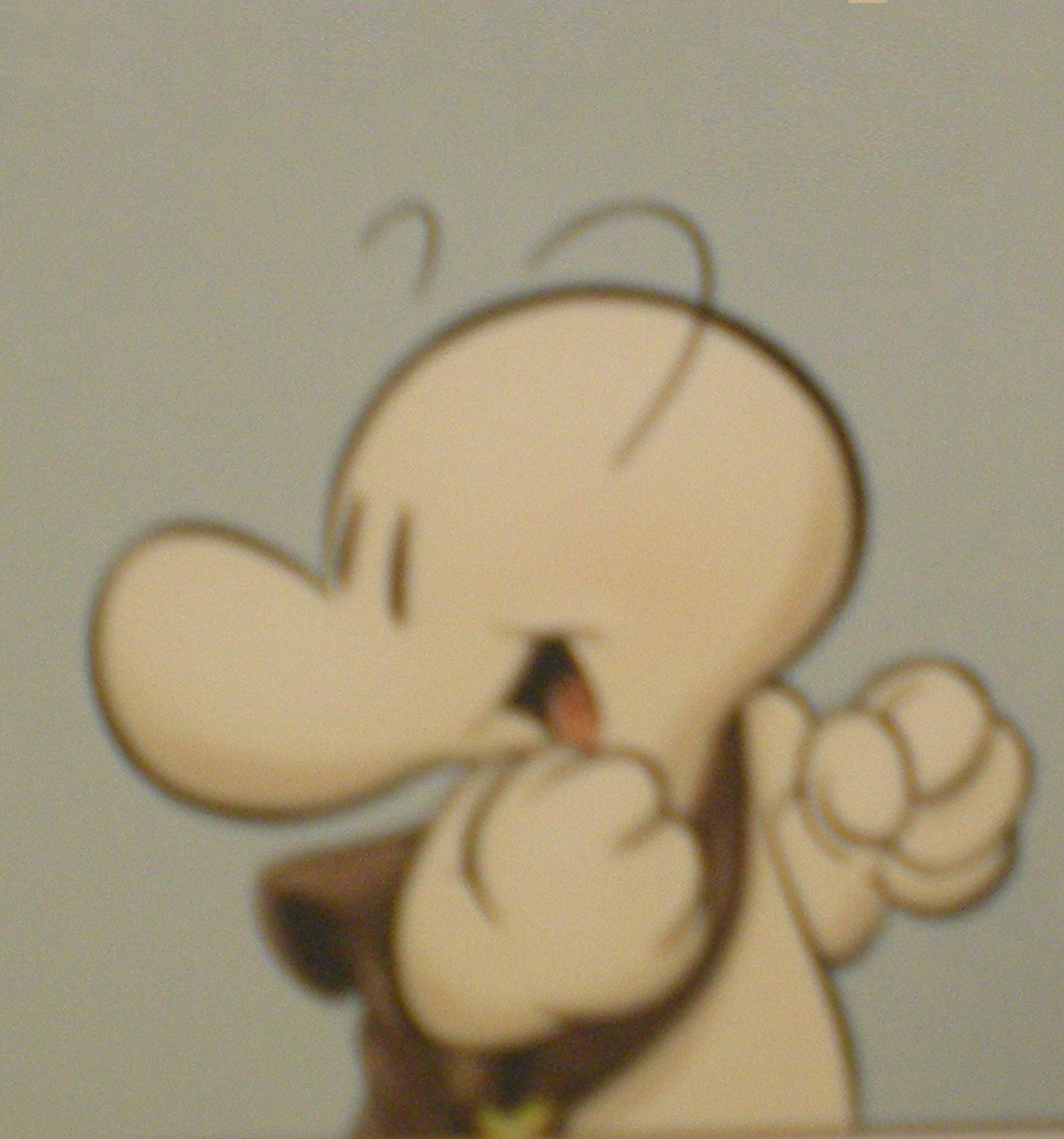 A cartoon-style character with a round head, large eyes, and a friendly expression