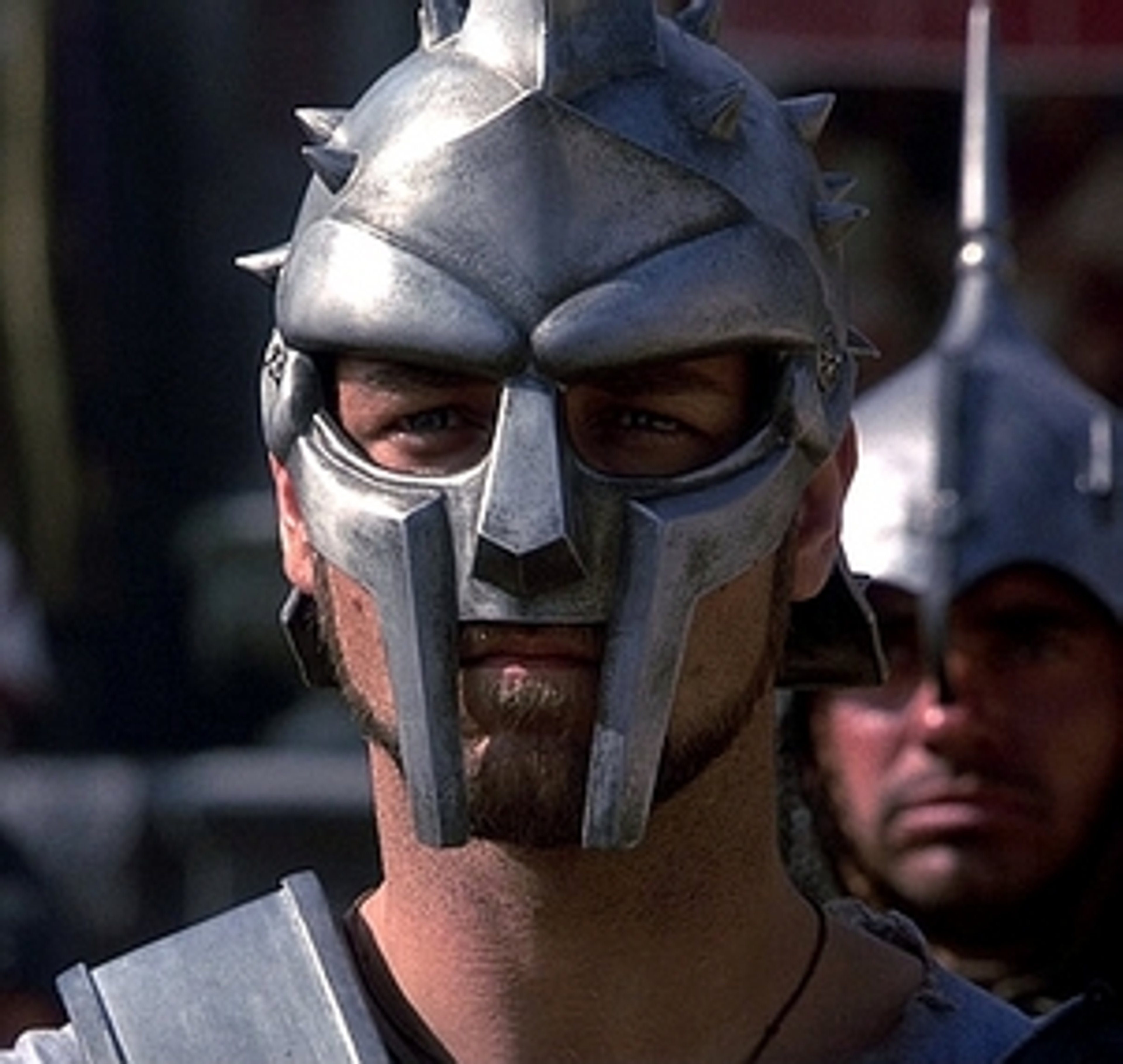 A heavily armored Roman soldier or gladiator with a stern expression