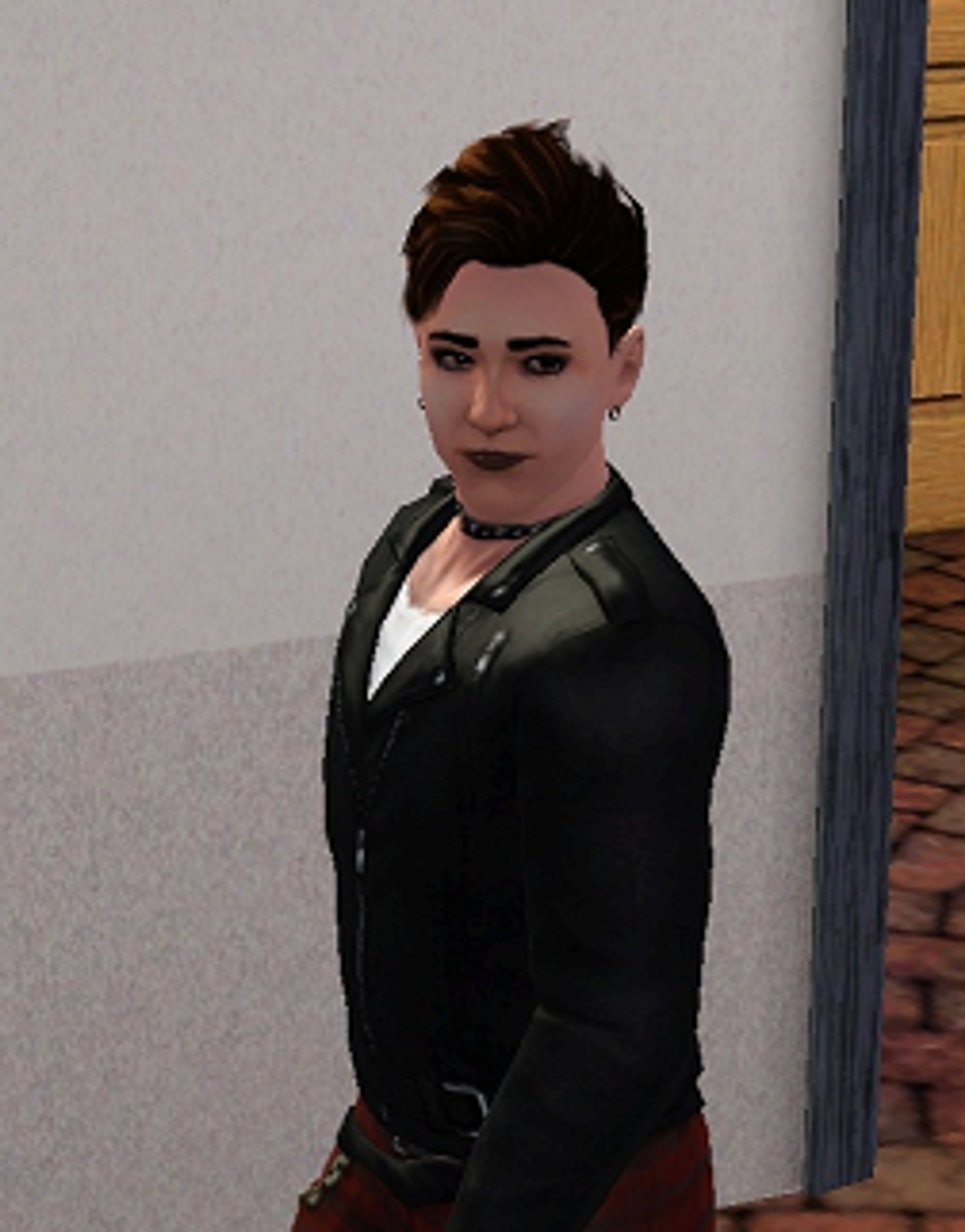 A young, charismatic man in a black suit jacket posing confidently