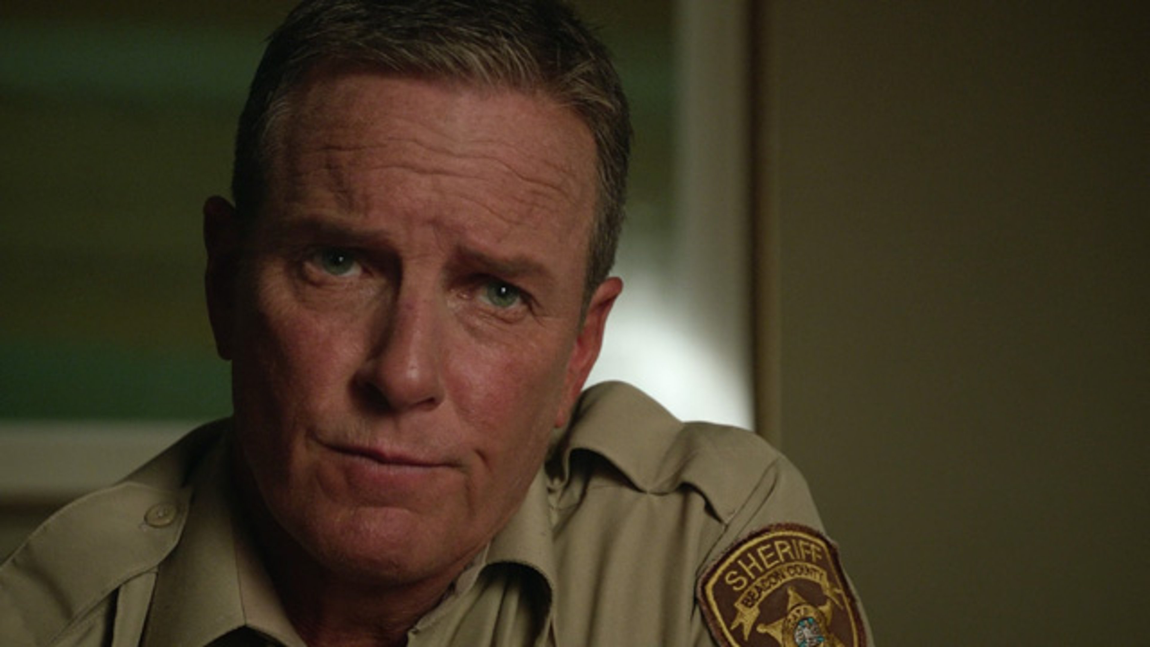 A middle-aged man in a sheriff's uniform