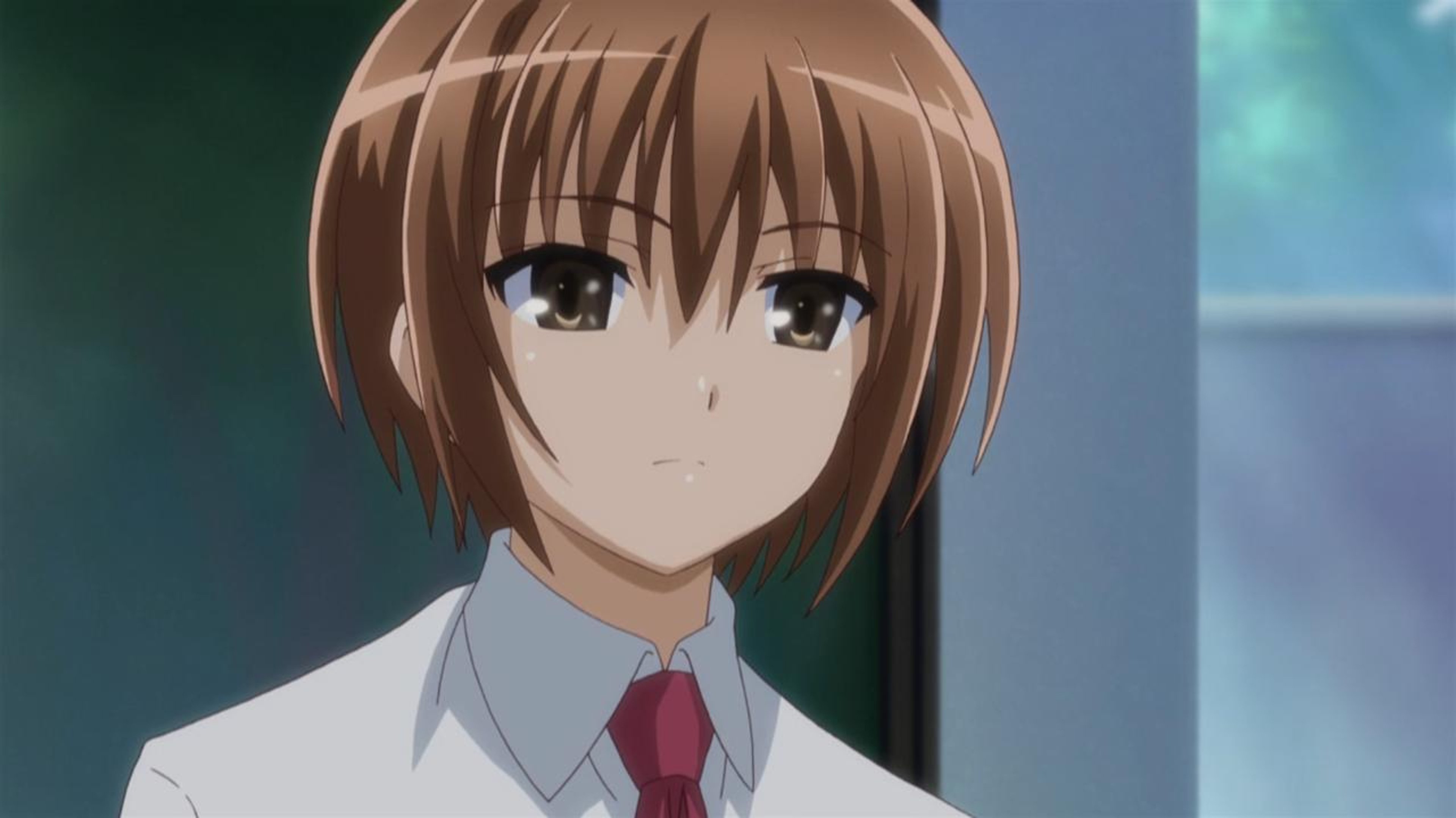 A young woman with brown hair and eyes, wearing a red tie and white shirt.