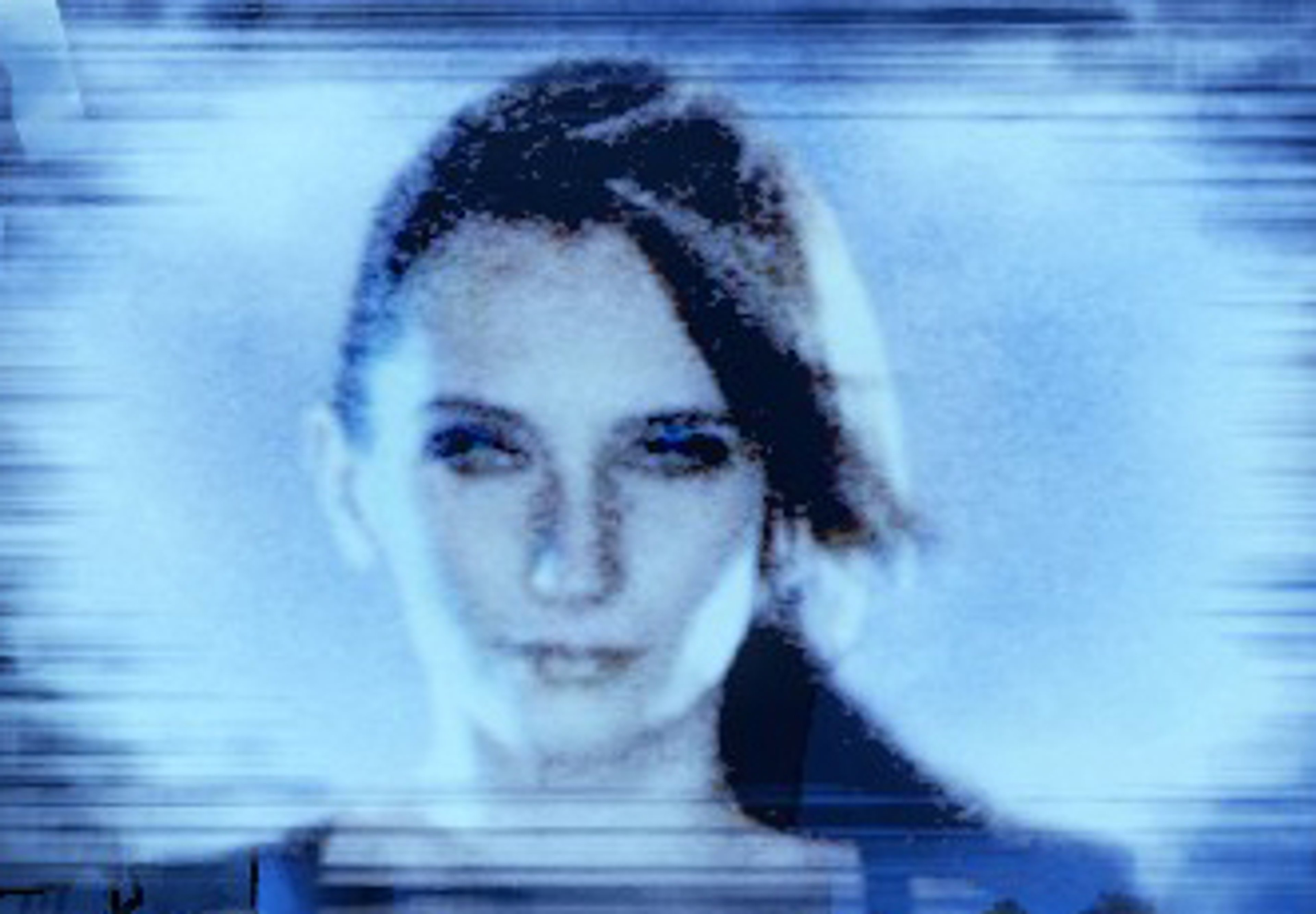 A pale-skinned woman with black hair and blue eyes, bearing glowing blue Siren tattoos