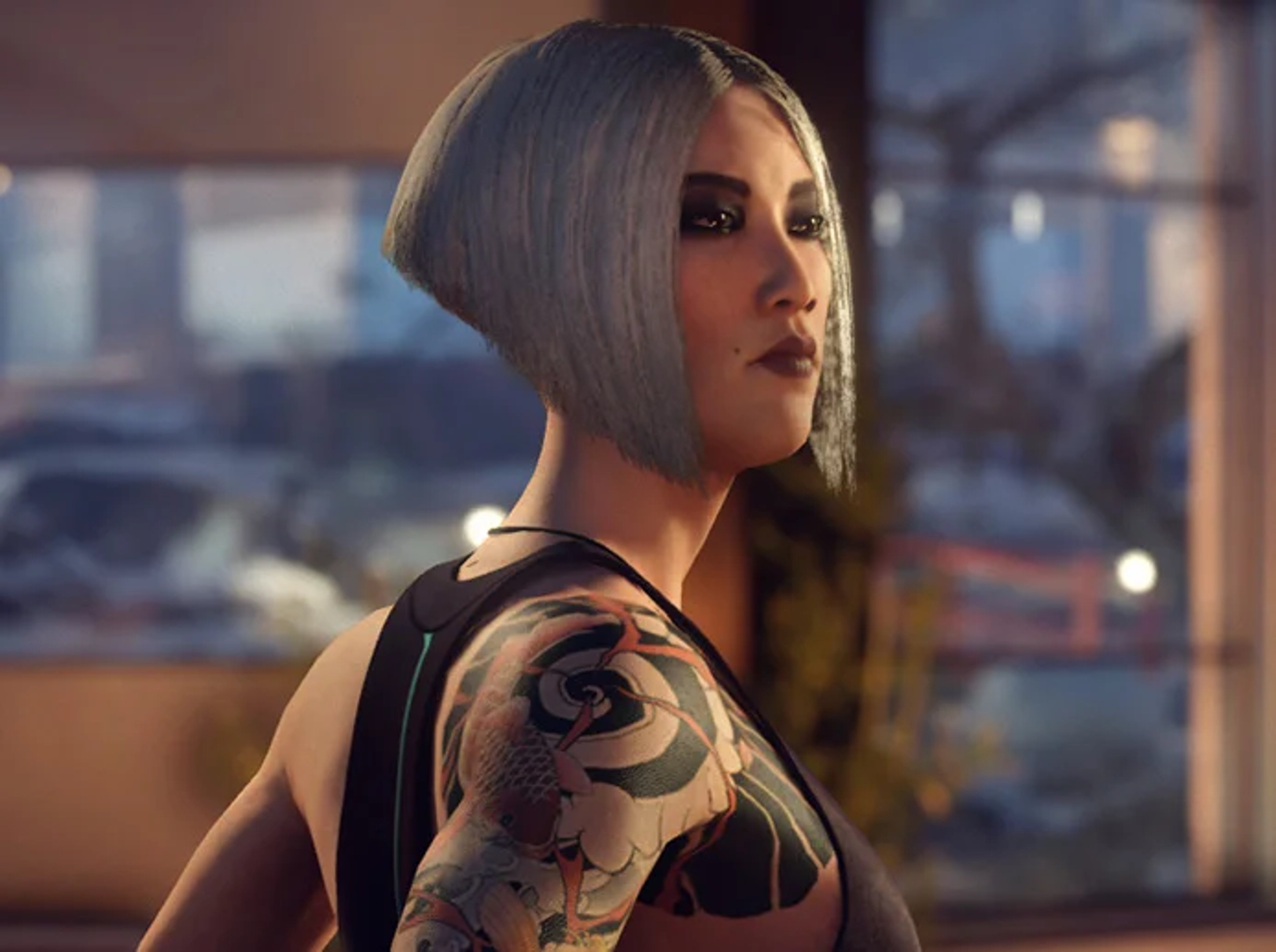 A woman with short, dark hair wearing a black suit jacket