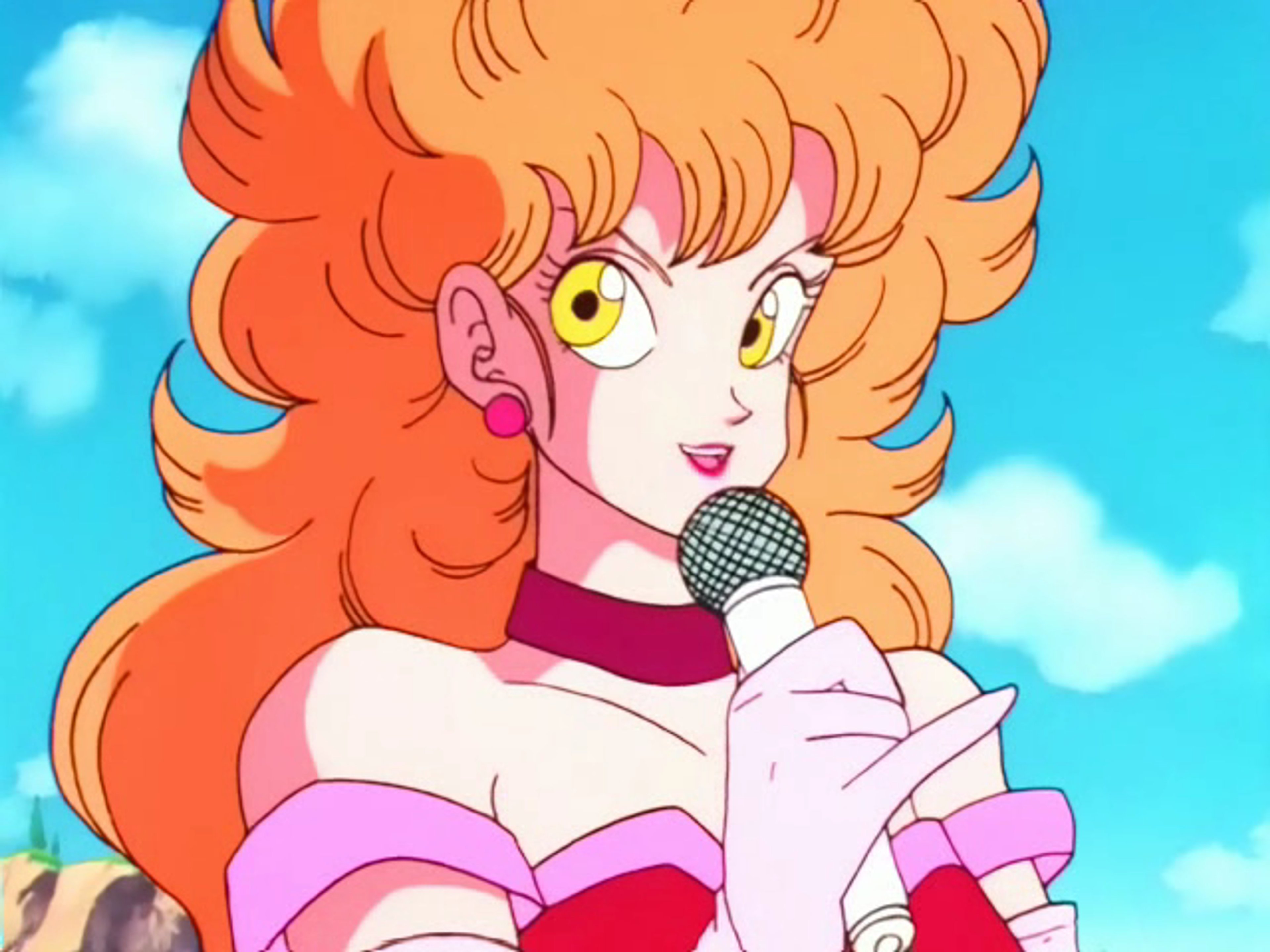 An animated female character with orange curly hair and a pink and white outfit, holding a microphone headset.