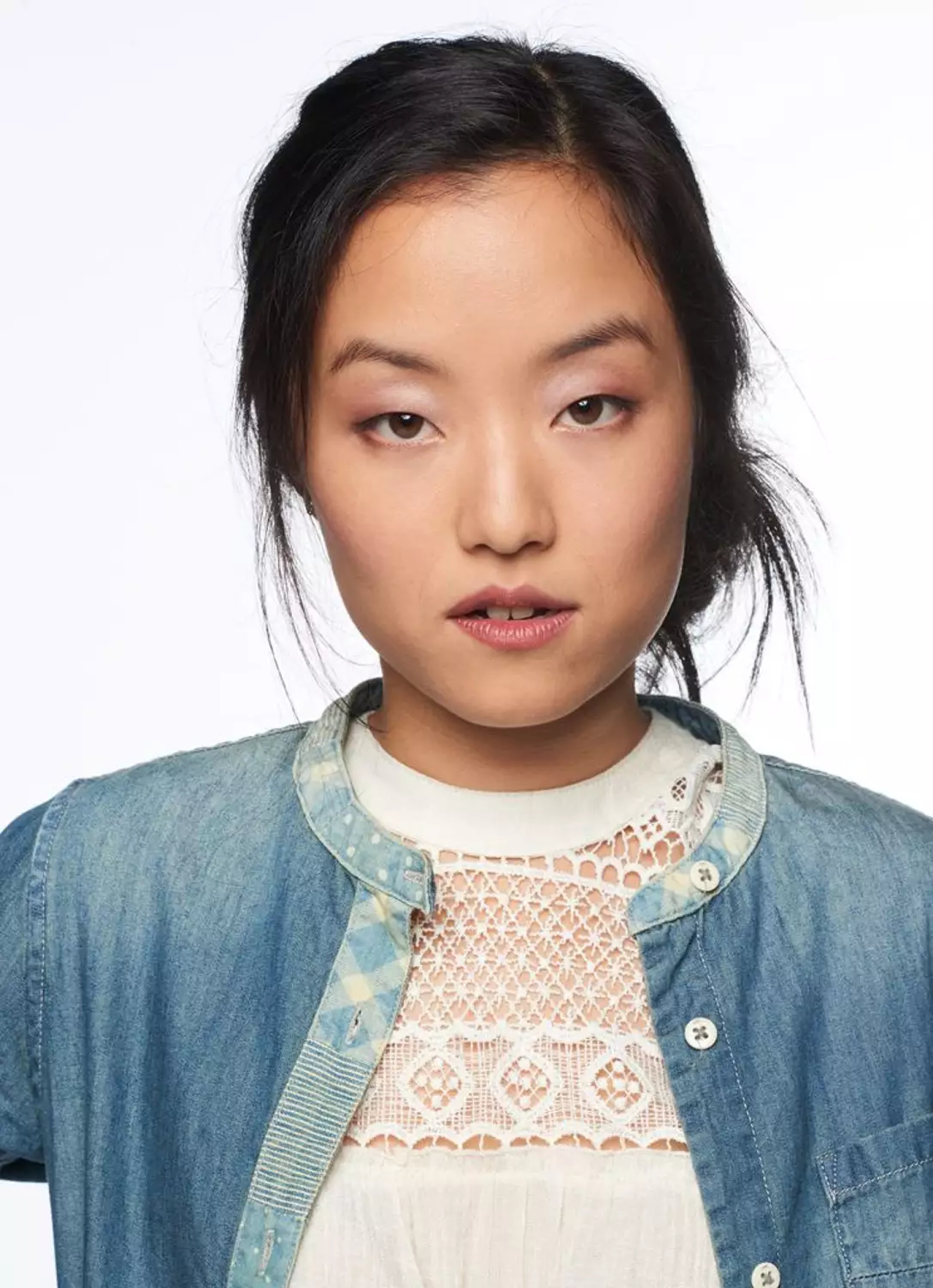 A young Asian woman with long dark hair wearing a denim jacket