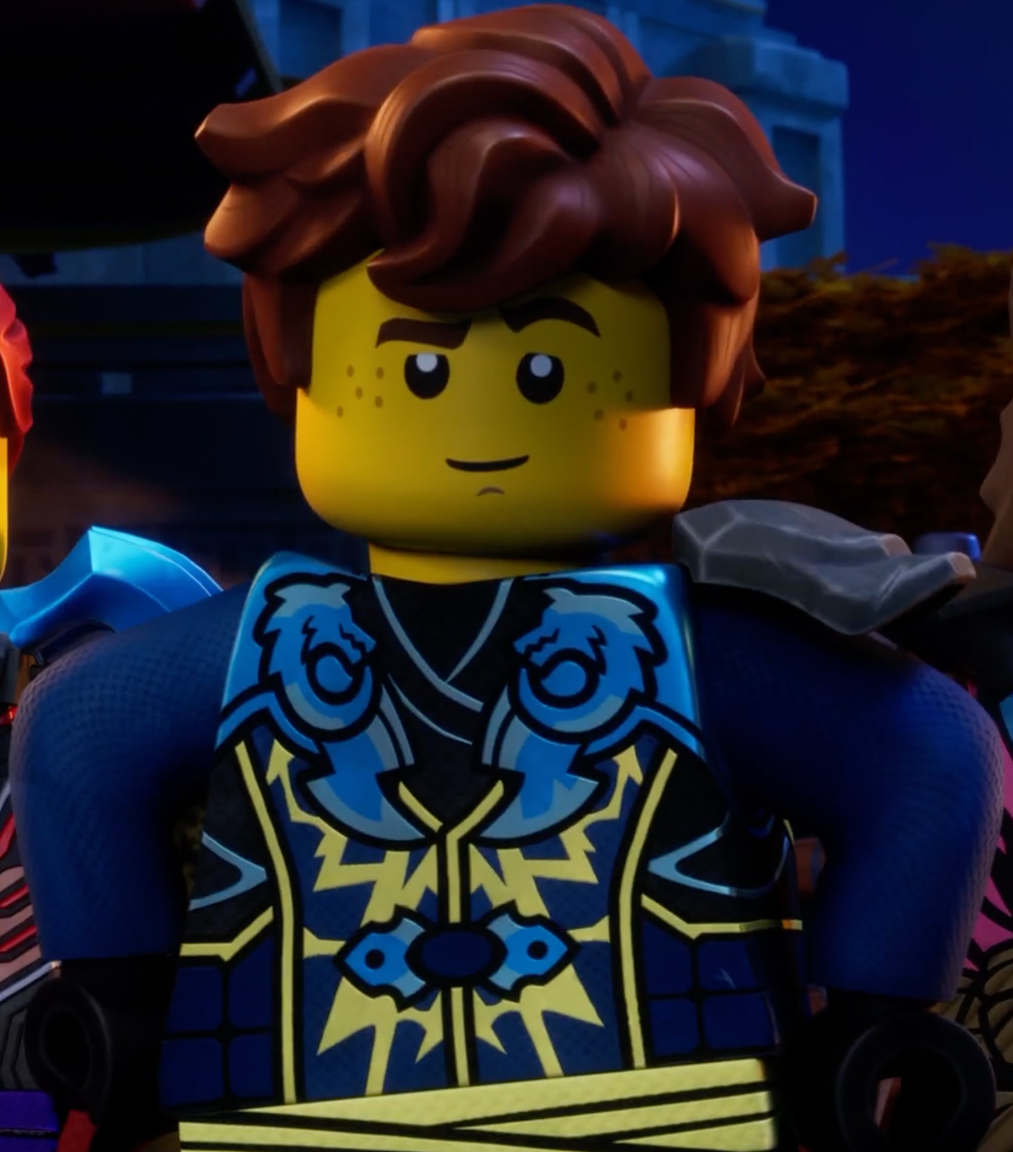 A LEGO minifigure character with blue and yellow outfit, red hair, and a friendly expression.