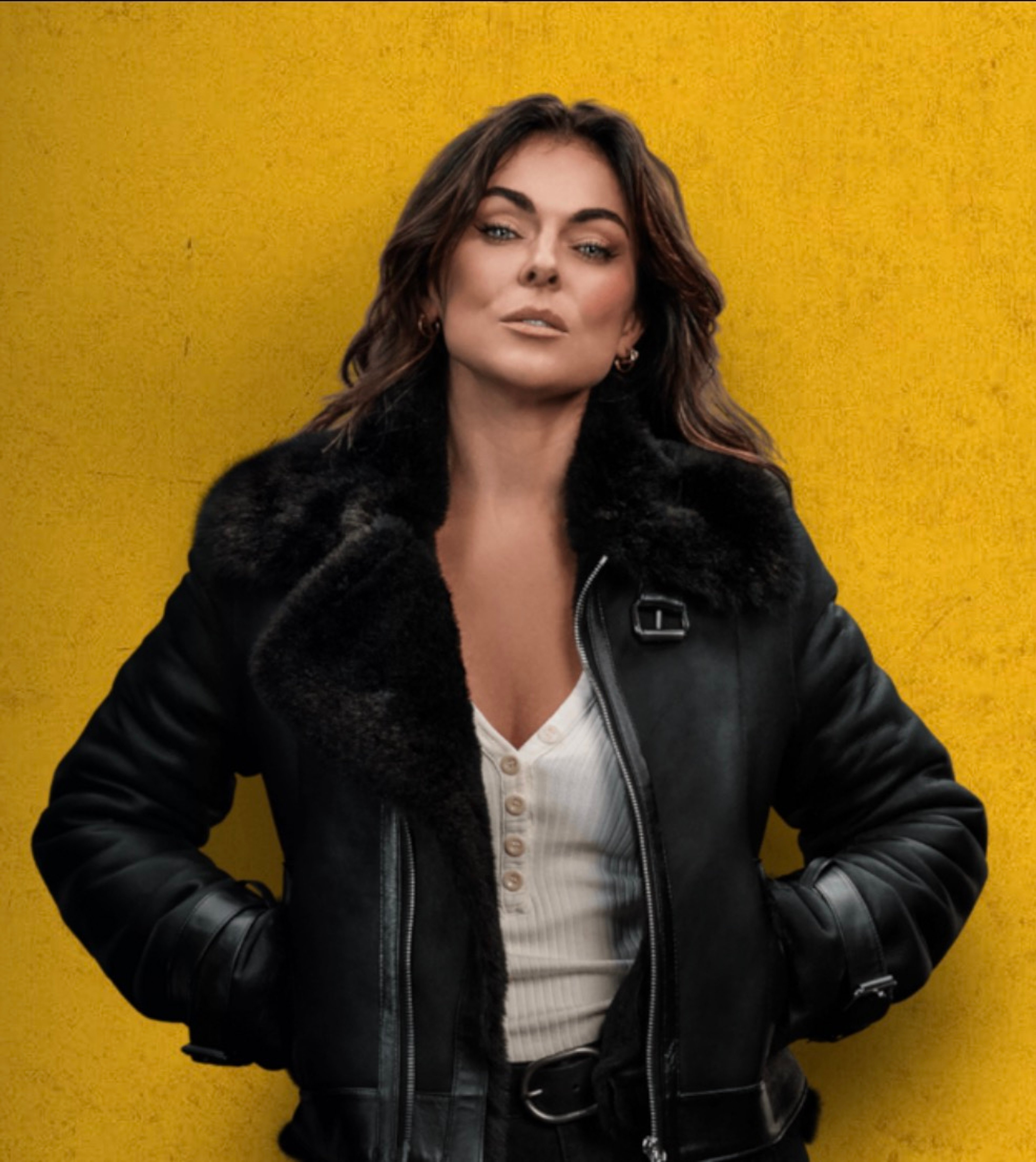 A woman with dark hair wearing a black leather jacket