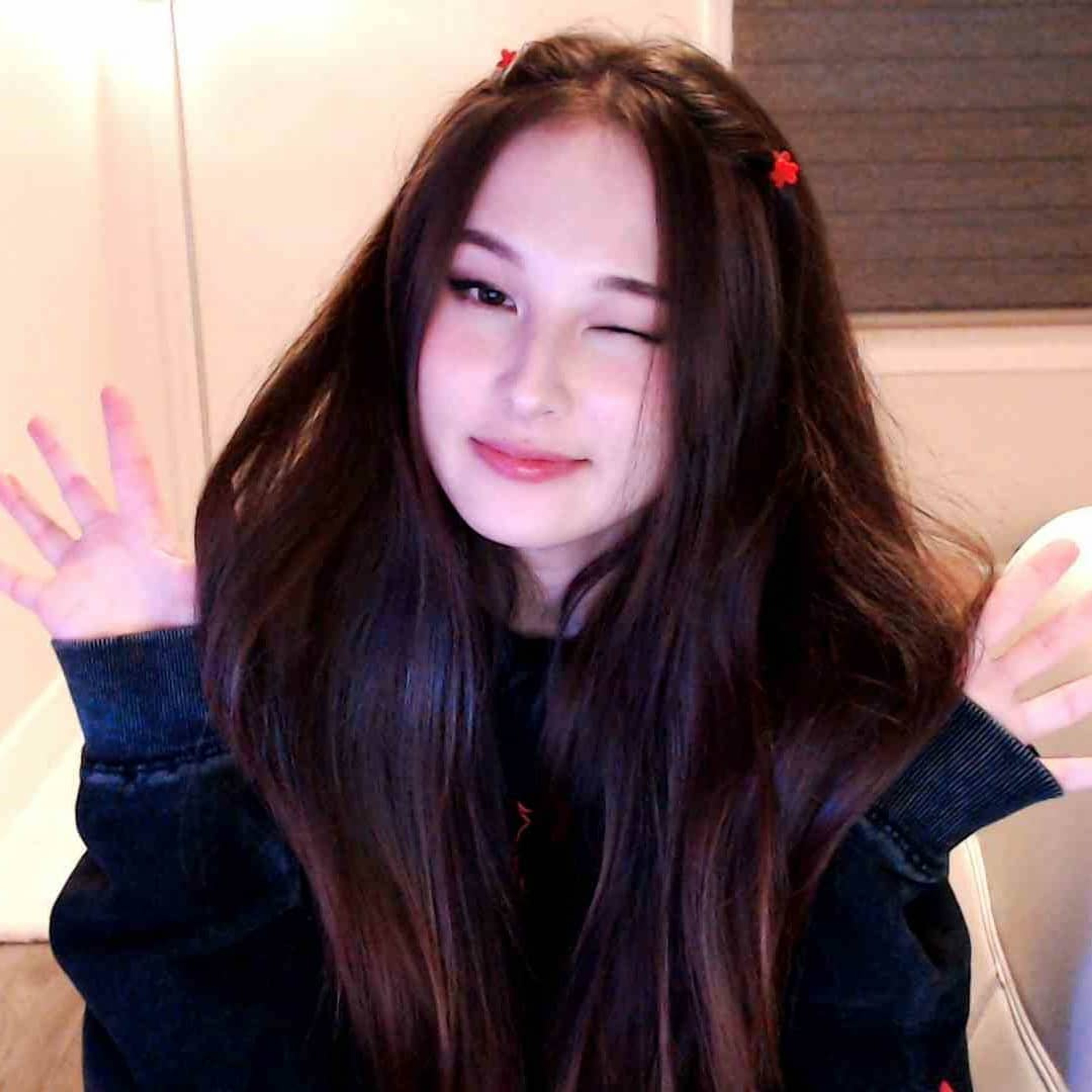 A young woman with long dark hair smiling at the camera
