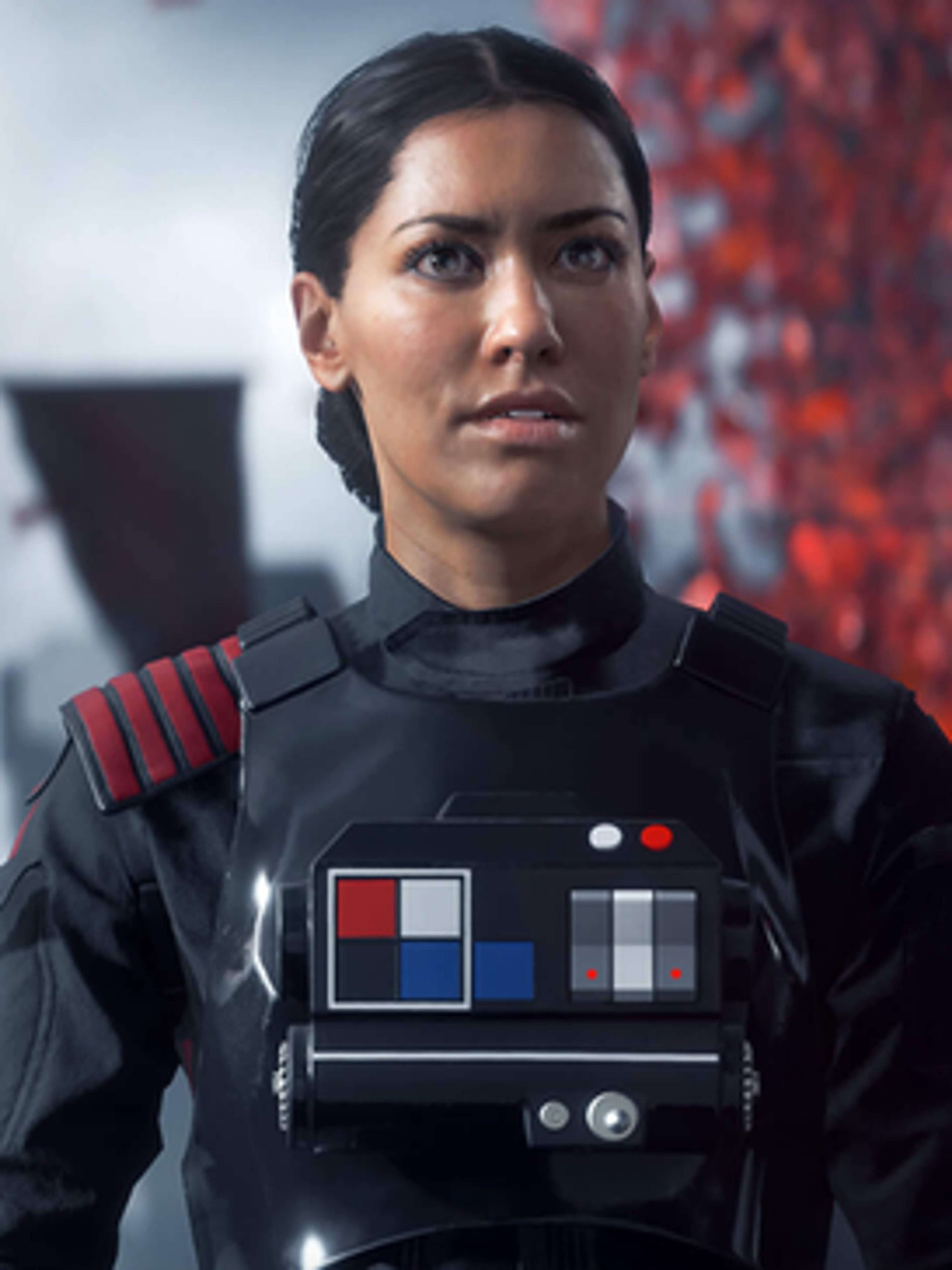 A woman in a black military-style uniform with red and gray accents, looking serious and determined.