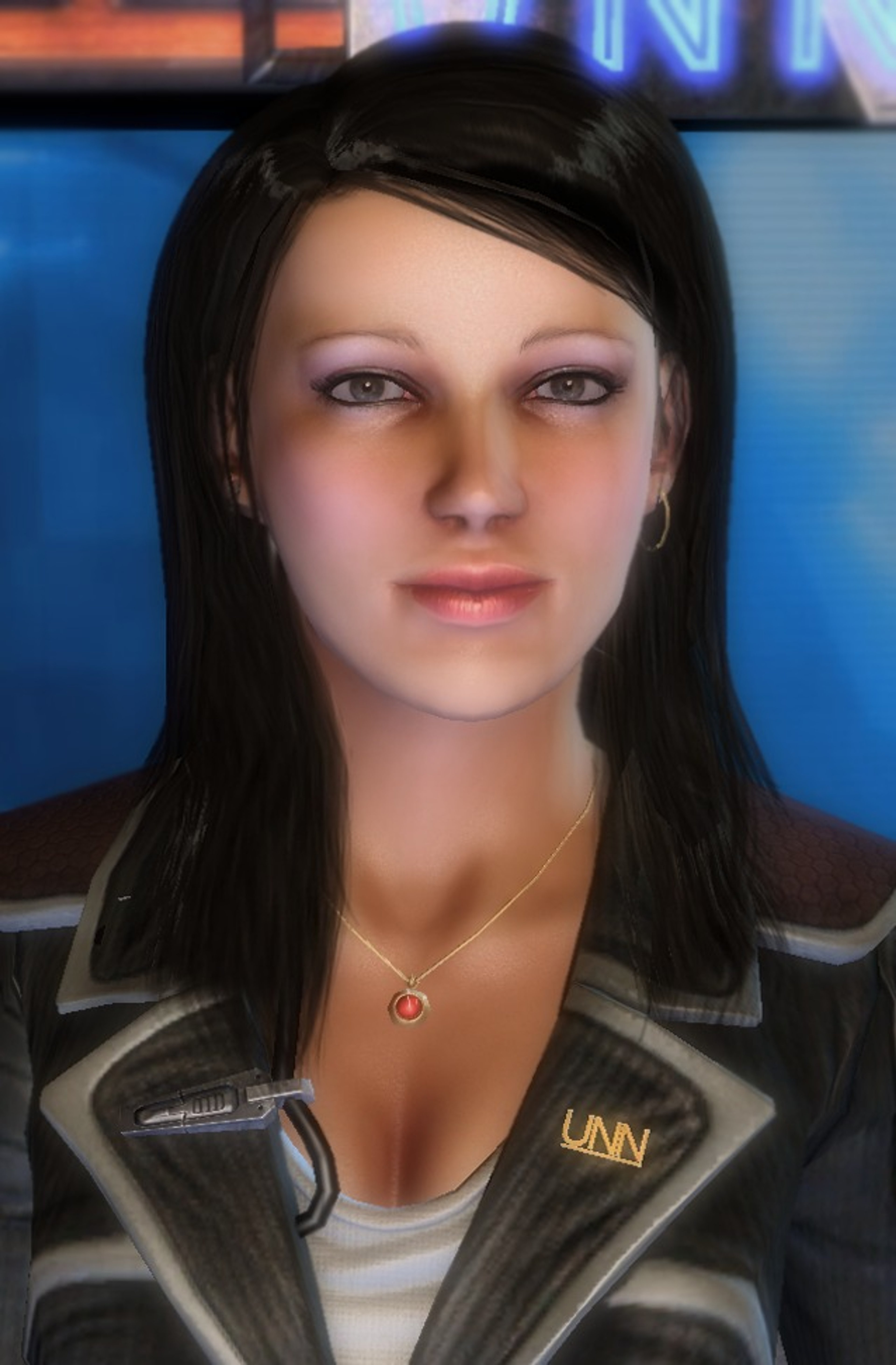 A woman with dark hair wearing a black jacket, looking serious