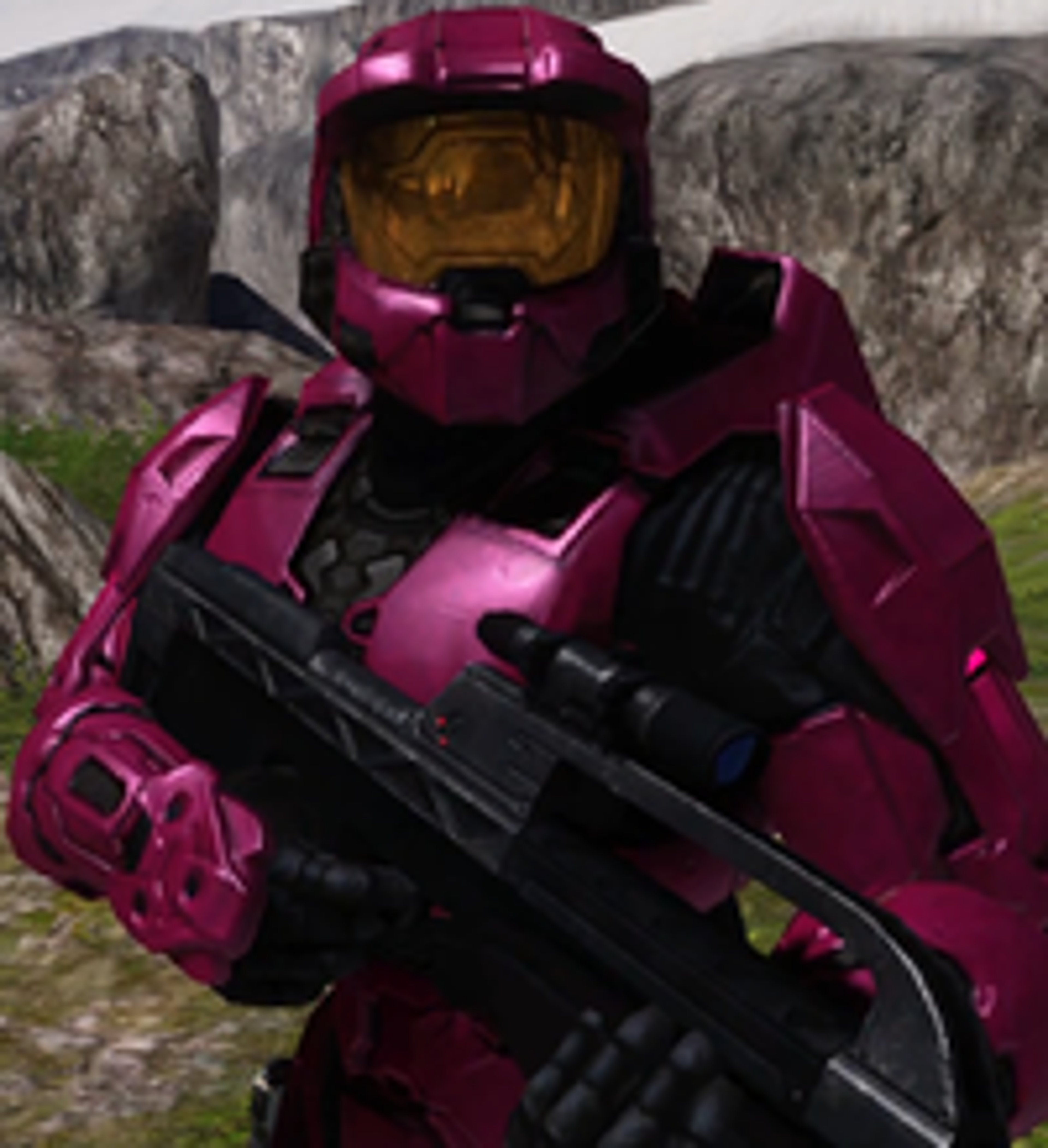 A character in red and black armor holding a large assault rifle in a rocky environment