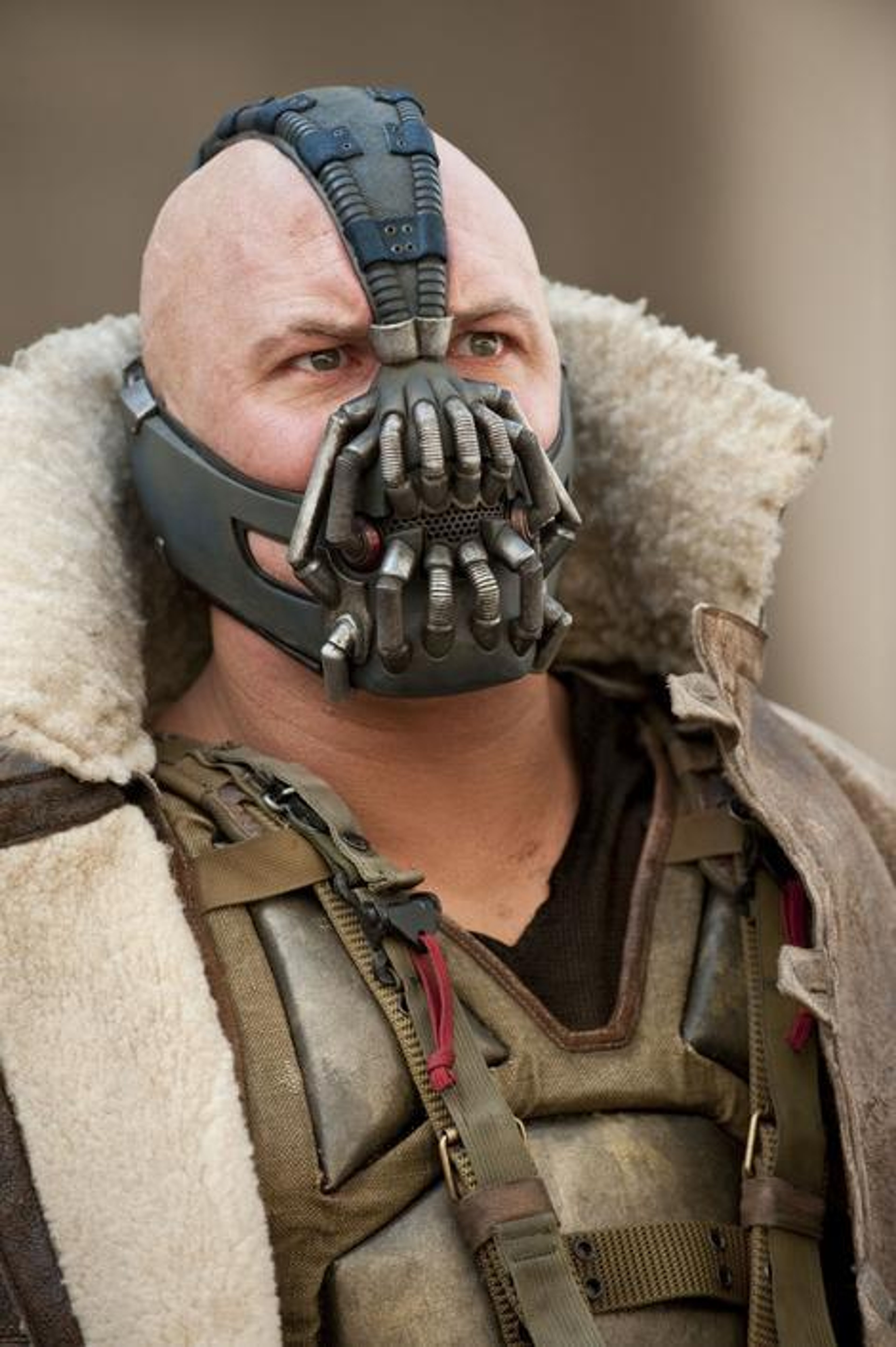 A large, muscular man wearing a dark, metallic mask with a breathing apparatus