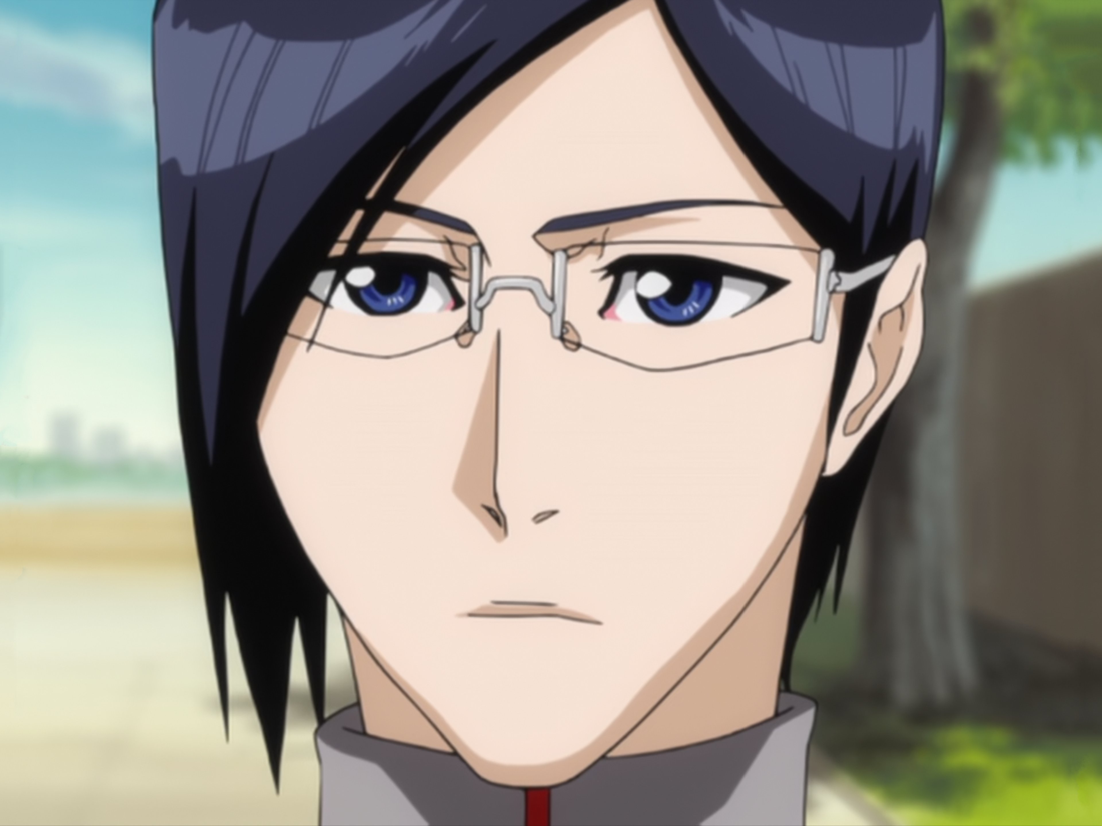 A young man with black hair and glasses wearing a white doctor's coat