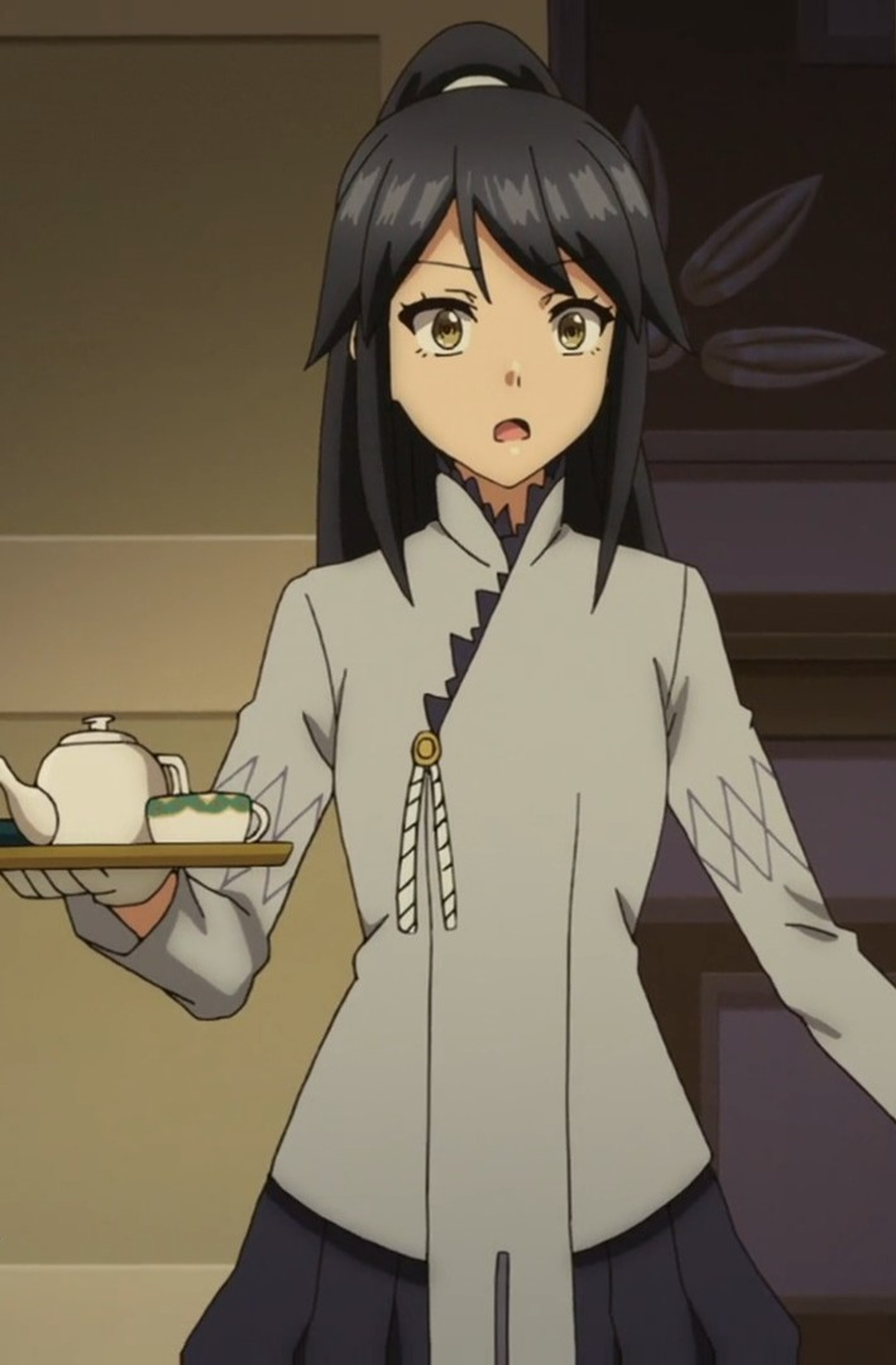 A young woman with dark hair in a ponytail wearing a light-colored outfit