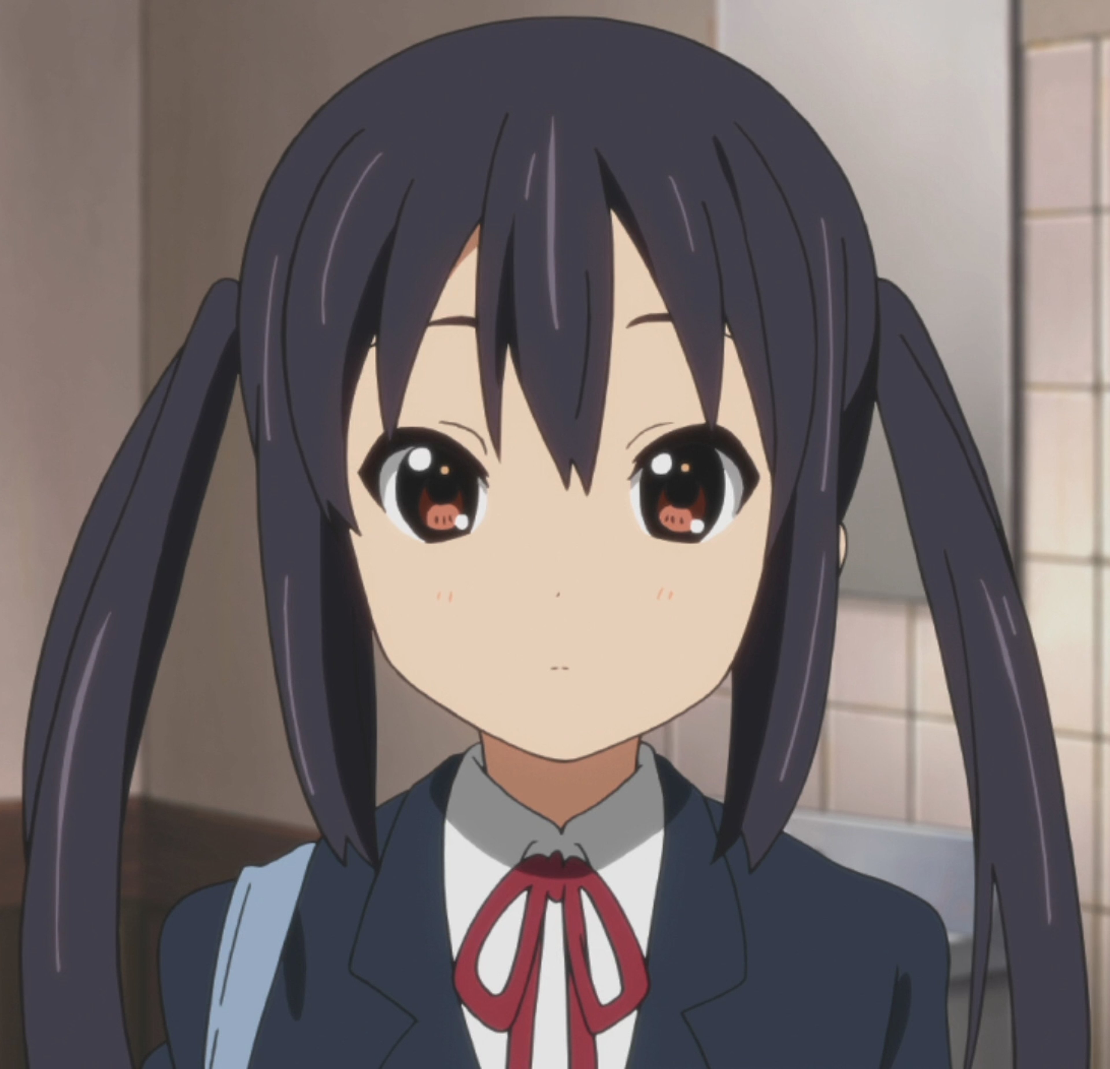 An anime-style girl with long black hair in twin tails, wearing a school uniform.